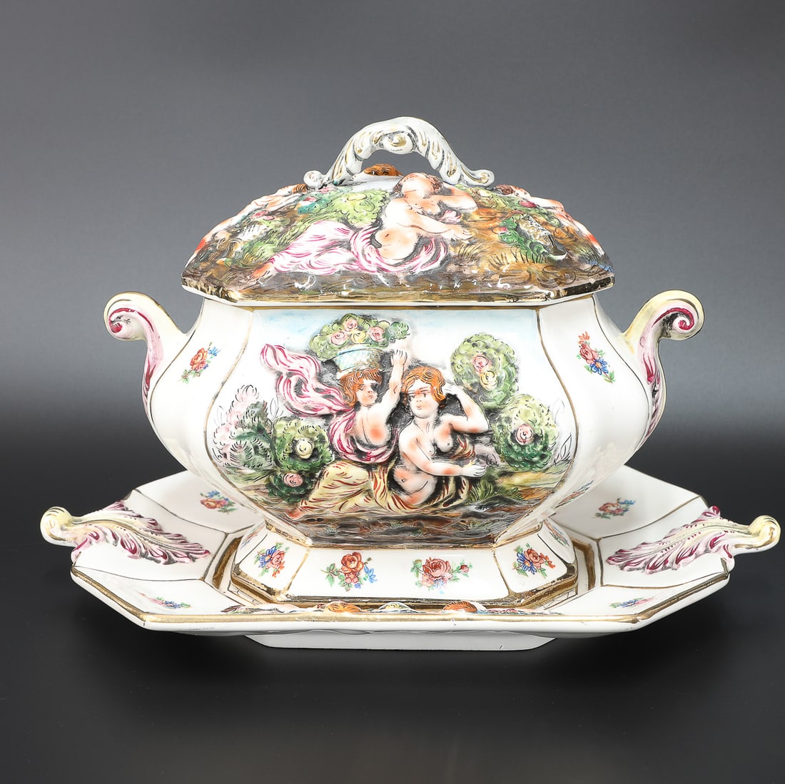 Vintage Italian Capodimonte Soup Tureen with Lid and Under Plate: Vintage Italian Capodimonte Soup Tureen with Lid and Under Plate, Charles Serouya and Son, Inc. NY Sticker on Bottom of Both Tureen and Under Plate, Octagonal Tureen Having Figural Cherub Lid and Urns