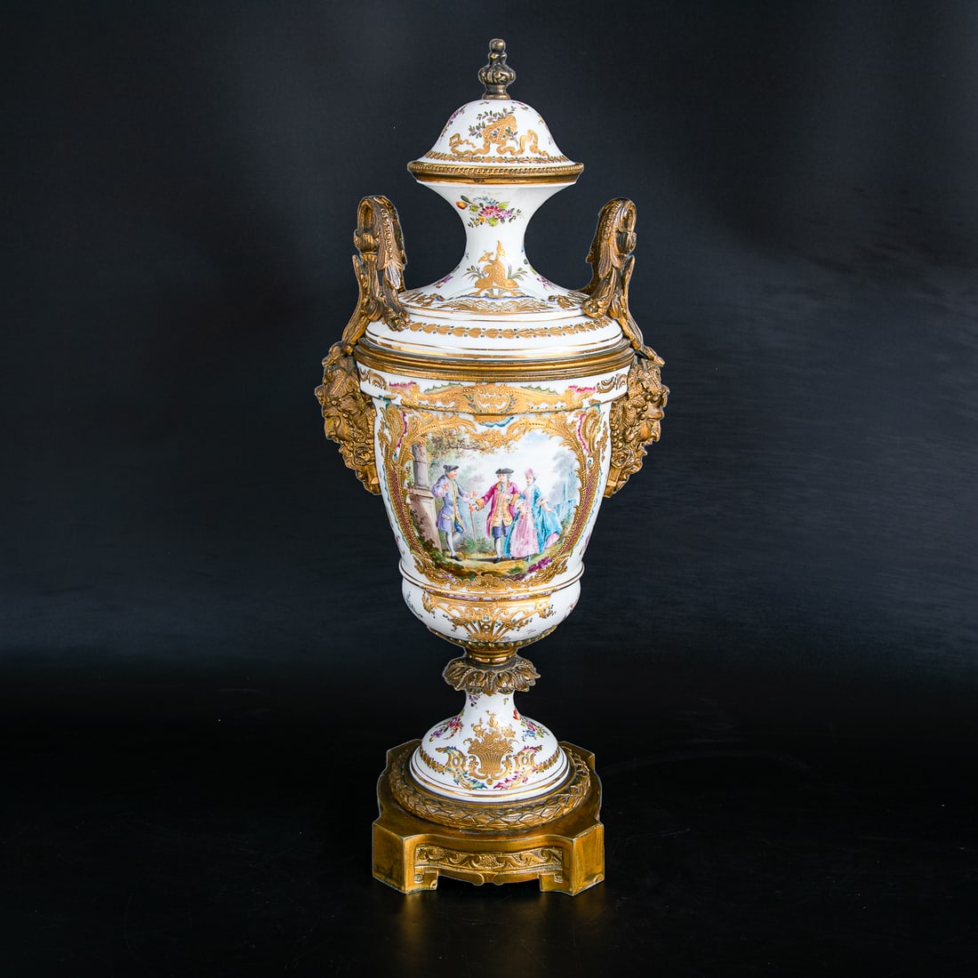 Late 19th C. French Porcelain Sevres Style Hand Painted Capped Urn: Late 19th C. French Porcelain Sevres Style Hand Painted Capped Urn, Having White Ground, Shaped Finial Top, Lid Features Multi Color Floral Designs, Delicate Gilt Ribbon and Leaf Designs, Double Leaf