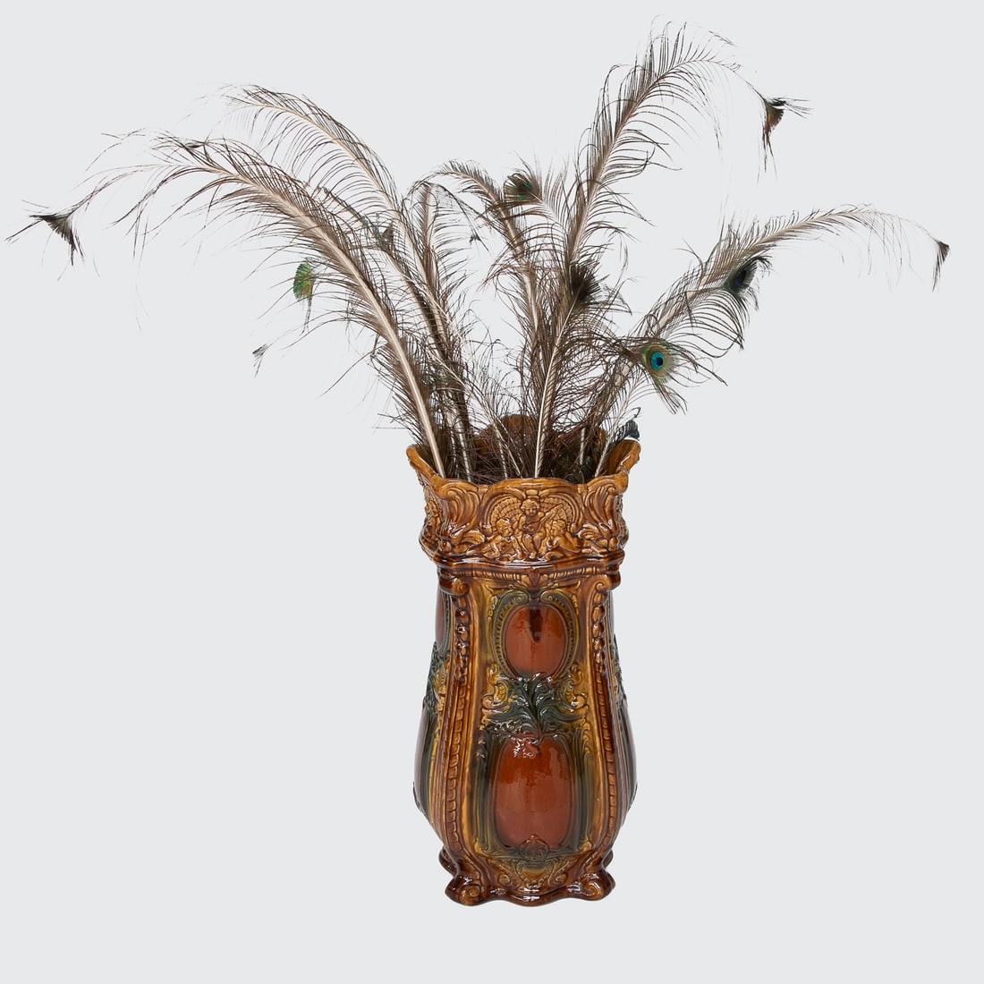 Vintage Majolica Glazed Umbrella Stand: Vintage Majolica Glazed Umbrella Stand, Having Shaped Top Featuring Seated Putti in Shell, Bell Flower Edges, Scroll Designs, Resting on Shaped Base, Featuring Ochre, Green and Rust Colors. 24.75"