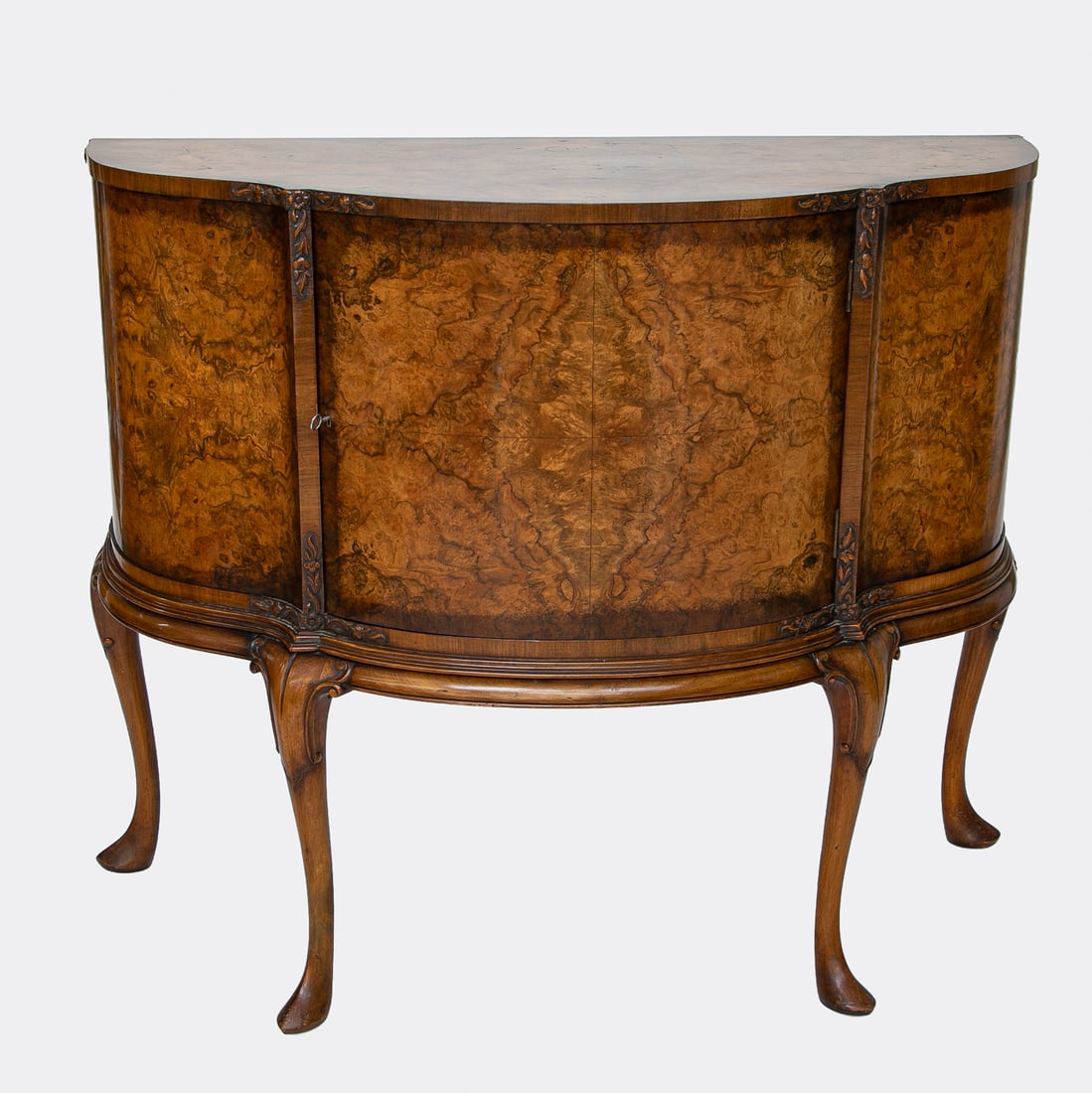 Antique Walnut and Burl Walnut Demi Lune Cabinet: Antique Walnut and Burl Walnut Demi Lune Cabinet, Having Demi Lune Shaped Top, One Cabinet Door, Top and Bottom Edges Feature Carved Leaf and Floral Designs, Molded Frieze, Resting on Cabriole Legs Fe