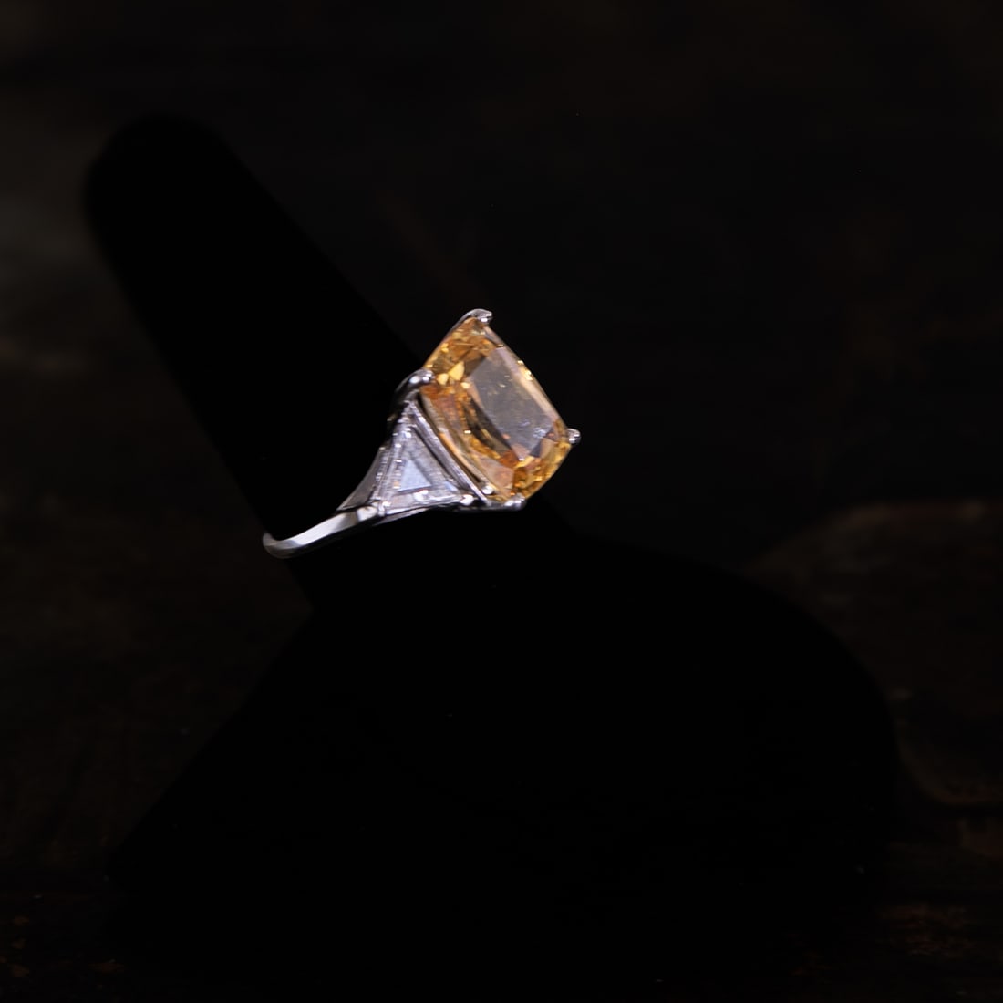 Platinum Natural Yellow Sapphire and Diamond Ring, Size 7: Platinum Natural Yellow Sapphire and Diamond Ring, Size 7, Consisting of One Cushion-Cut Yellow Sapphire Weighing 10.02 Carats and Two (2) Trillion-Cut Natural Diamonds Weighing 1.10 Carats.