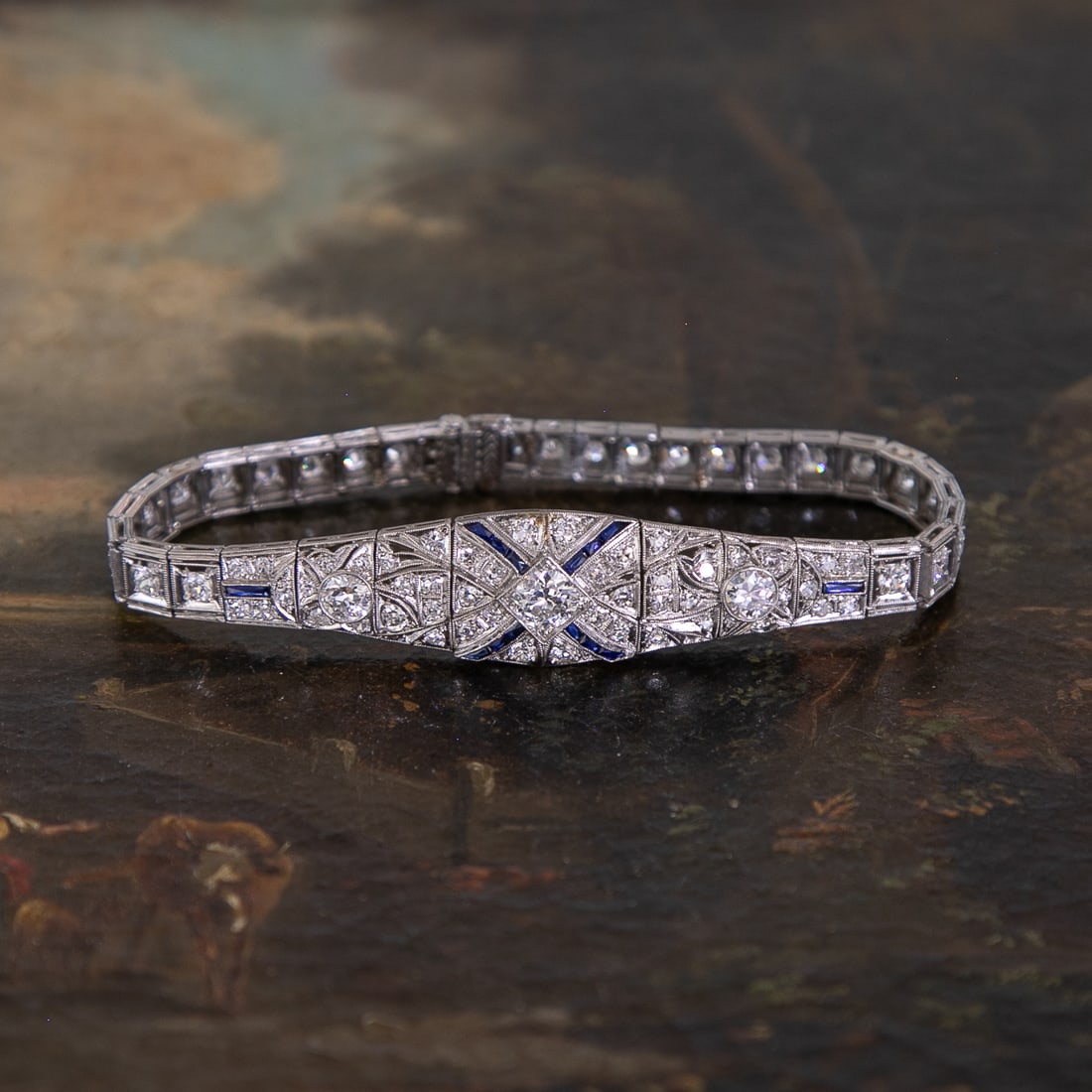 Art-Deco Platinum Natural Diamond Bracelet with Blue Sapphire Accents: Art-Deco Platinum Natural Diamond Bracelet with Blue Sapphire Accents, Consisting of Seventy-Nine (79) Round Diamonds Weighing 4.50 Carats. Diamonds are G in Color and VS in Clarity.