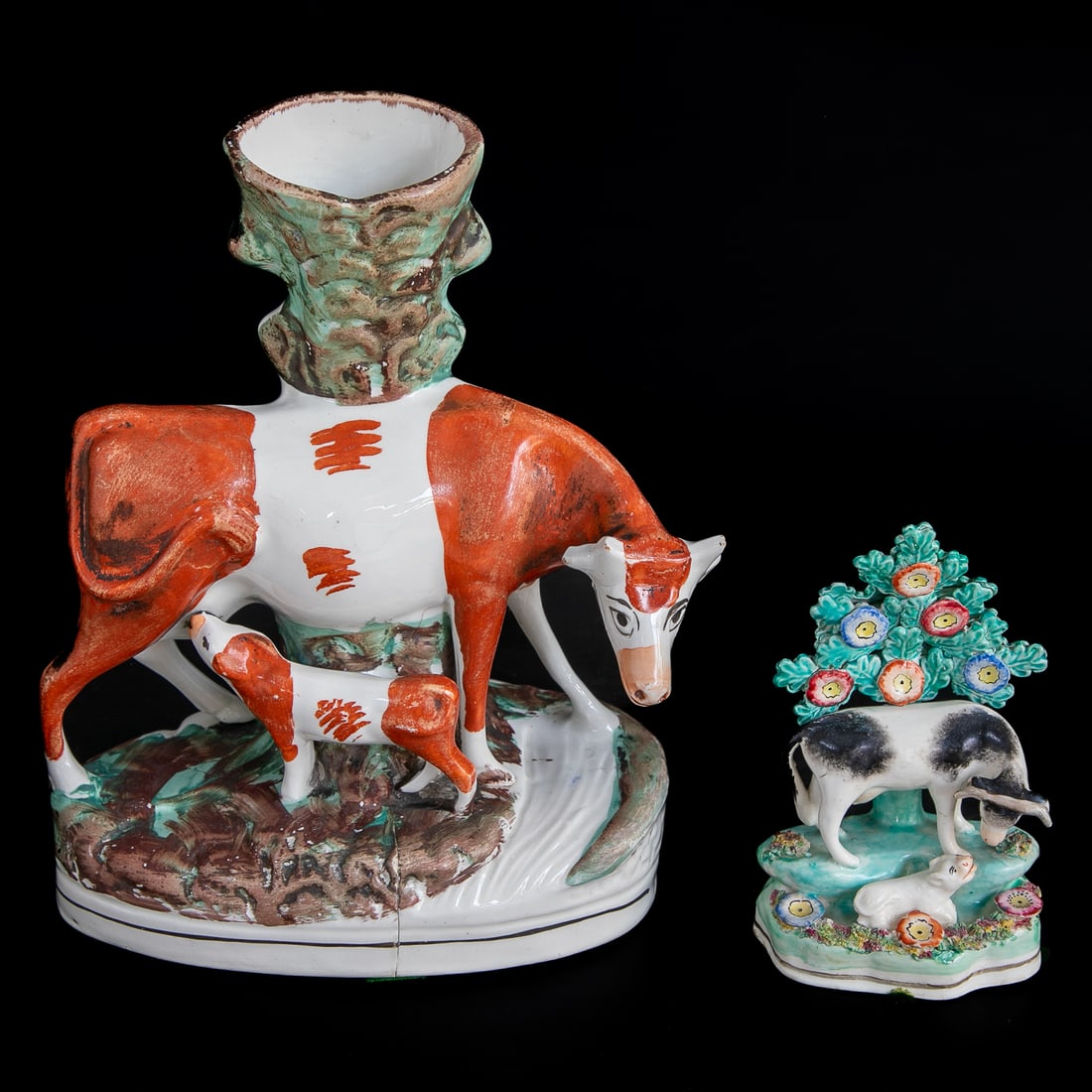 Late 19th C. Staffordshire Cow Figures, Two Total: Late 19th C. Staffordshire Cow Figures, Two Total, Includes One Cow Standing by Tree Featuring Flower Designs and Looking Over Baby Calf, Resting on Ground Form Base Featuring Flowers, 6.5" High, 4" W