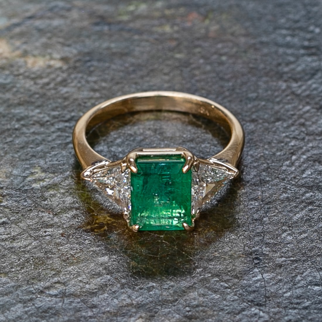 18K Yellow Gold Emerald and Diamond Ring, Size 6.25: 18K Yellow Gold Emerald and Diamond Ring, Size 6.25, Consisting of One Natural Emerald-Cut Emerald Weighing 1.85 Carats and Two (2) Natural Trillion-Cut Diamonds Weighing. Diamonds are G in Color and 