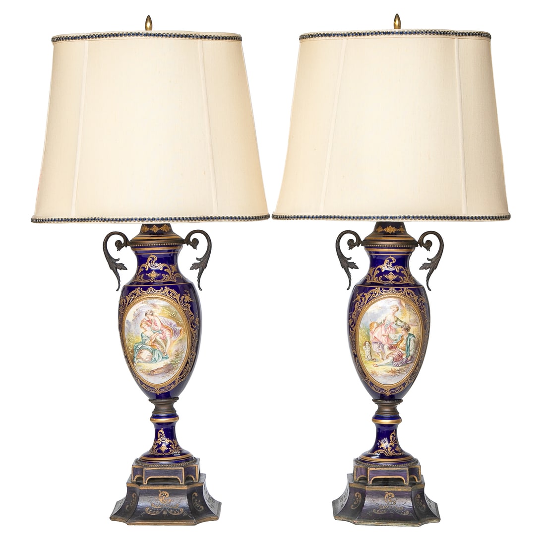 19th C. French Porcelain Sevres Style Urns Converted Into Table Lamps, Pair: 19th C. French Porcelain Sevres Style Urns Converted Into Table Lamps, Pair, Having Cobalt Blue Ground, Leaf Scroll Form Handles, Back Panels Feature Landscape Scenes Featuring Castles Surrounded in G