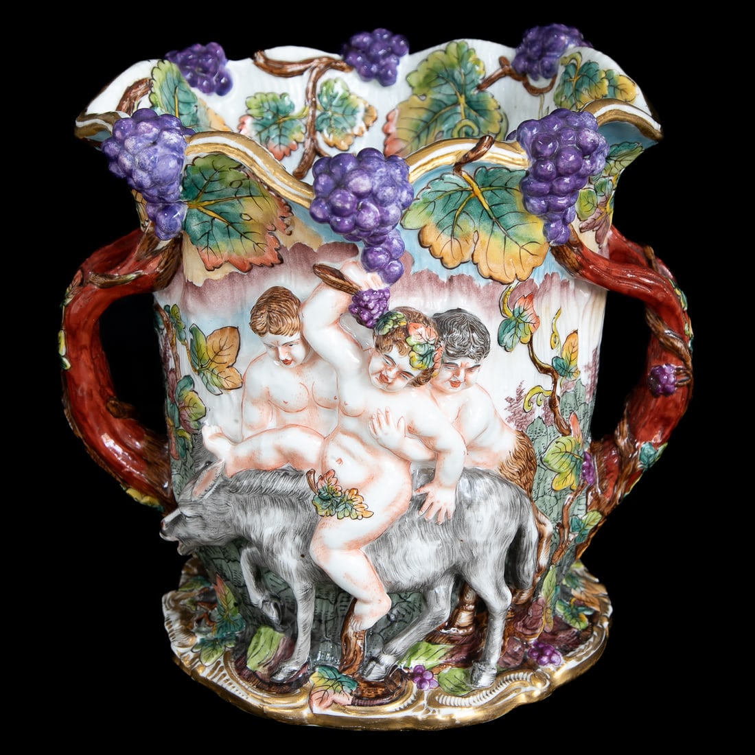 Vintage Italian Capodimonte Porcelain Champagne/Wine Cooler: Vintage Italian Capodimonte Porcelain Champagne/Wine Cooler, Having Grape Clusters Along Top Edge, Grape Leaves On Interior and Exterior of Top, Gold Edges, One Side Depicts Two Satyrs Guiding Bacchus