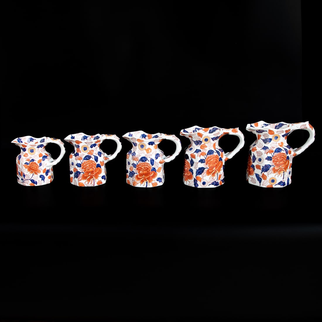 Late 19th/Early 20th C. Victoria Ironstone Porcelain Pitchers/Jugs, Five Total Pieces: Late 19th/Early 20th C. Victoria Ironstone Porcelain Pitchers/Jugs, Five Total Pieces, Graduated Sizes, Having Octagonal Shape Bodies Featuring Cobalt Blue Leaf and Bittersweet Floral Designs, Handle 