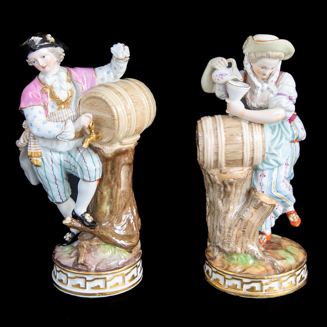 Late 19th C. Meissen Figures, Male and Female: Late 19th C. Meissen Figures, Male and Female, Both Standing Near Wine Kegs Atop Tree Trunk, Both Wearing Hats, Standing on Ground Form Bottom, Terminating in Circular Base Featuring Gold Accents, Bot