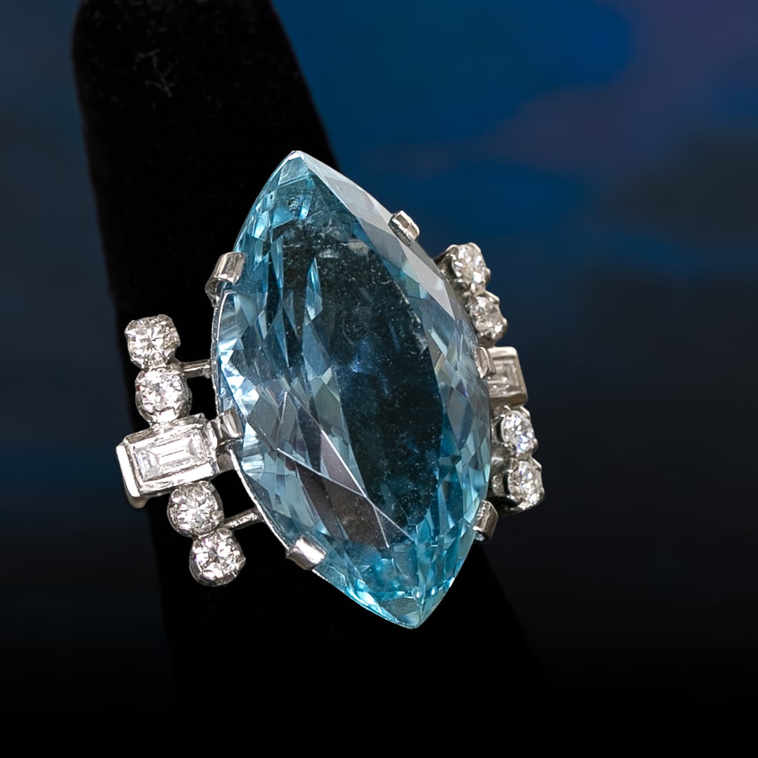 Platinum Natural Aquamarine and Diamond Ring, Size 7: Platinum Natural Aquamarine and Diamond Ring, Size 7, Consisting of One Marquise Cut Aquamarine Weighing 25.00 Carats and Ten (10) Natural Round and Baguette Diamonds Weighing .50 Carats.