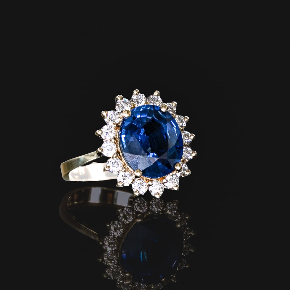 18K Yellow Gold Sapphire and Diamond Ring, Size 6.75: 18K Yellow Gold Sapphire and Diamond Ring, Size 6.75, Consisting of One Natural Oval Blue Sapphire Weighing 5.00 Carats and Sixteen (16) Natural Round Brilliant-Cut Diamonds Weighing .60 Carats.