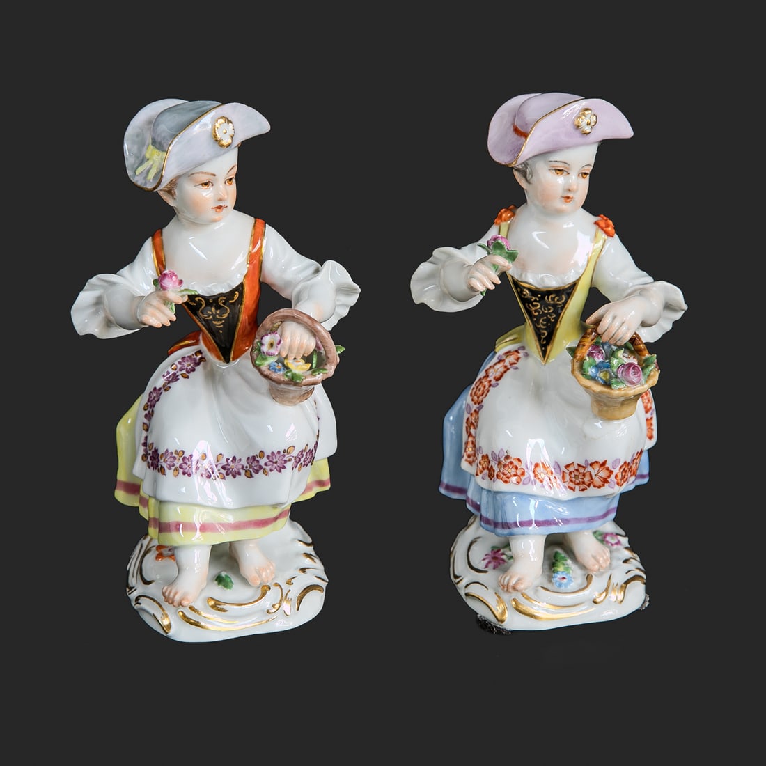 Late 19th/Early 20th C. Meissen Young Female Figures, Two Total: Late 19th/Early 20th C. Meissen Figures, Two Total, Both Depicting Young Female Wearing Fancy Chapeau, Dress with Apron, Holding Basket of Flowers in One Hand and Single Flower in the Other Hand, Rest