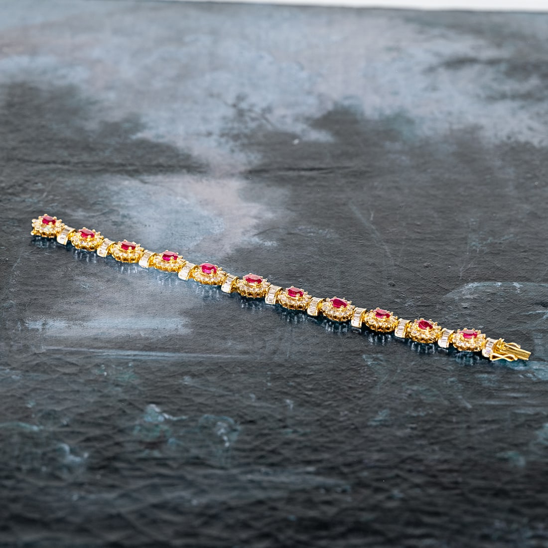 6.5 Inch 18K Yellow Gold Natural Ruby and Diamond Bracelet: 6.5 Inch 18K Yellow Gold Natural Ruby and Diamond Bracelet, Consisting of Eleven (11) Natural Oval Rubies Weighing 6.75 Carats and Two Hundred Thirty-One (231) Natural Round Brilliant-Cut and Baguette