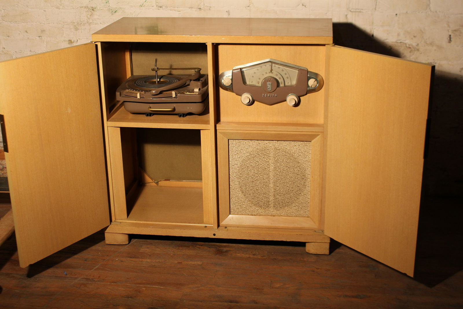 Zenith Stereo Record Player: Zenith brand, blond wood, two door cabinet with tuner, tube amp and record player. One speaker.