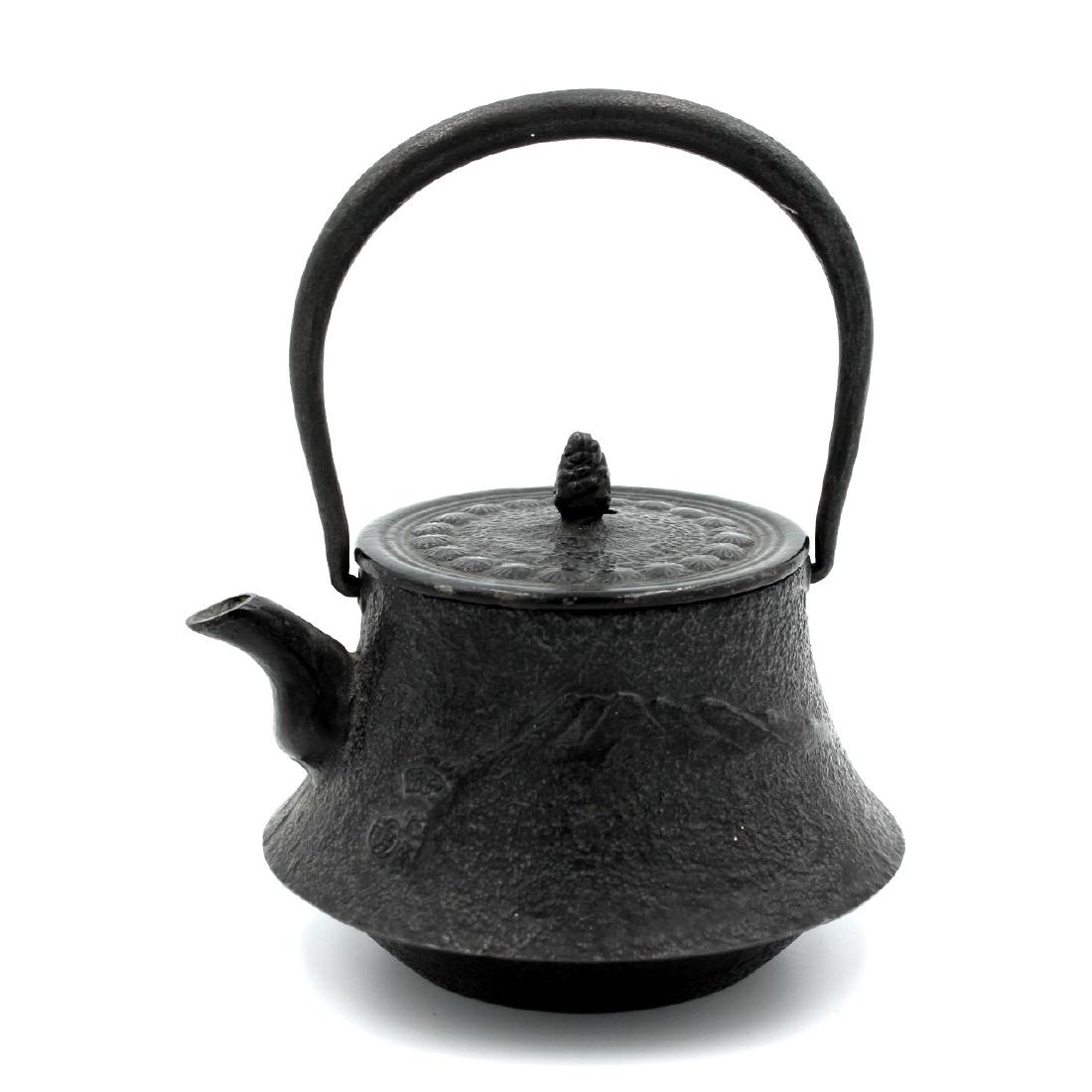 Vintage Tetsubin Nambu Hobun-Dou Cast Iron Teapot: Estimate: $150 - $200 Description: Vintage Japanese cast iron kettle or teapot with wild horse and mountains in relief on the sides, cherry blossoms encircle the lid with a pinecone button. Tetsubin N