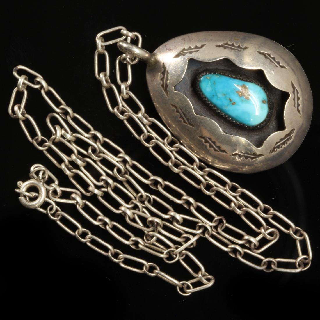 Turquoise and Silver Pendant Necklace, Navajo: Estimate: $95-$125 Description: Vintage Turquoise and Silver pendant necklace, Navajo. Hallmarked "TG" for possibly Timothy Guerra. 18 inch chain, 14.5mm stone, pendant is 1.25 inches tall. 