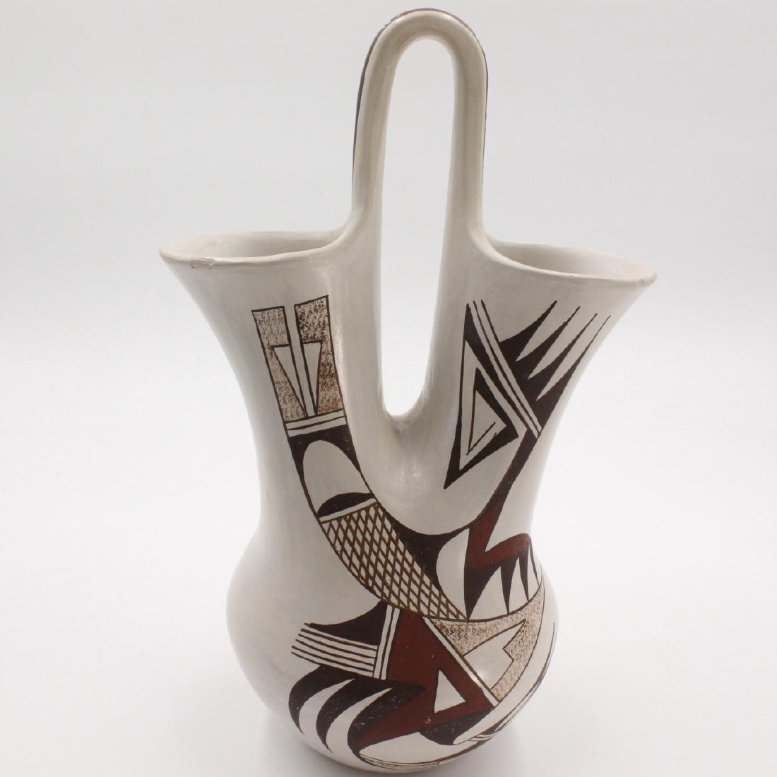 Joy Navasie , Hopi Pueblo Wedding Vase: Estimate: $400-$450 Description: Hopi Pueblo, Joy Navasie "Frogwoman" 10 tall x 4.5 diameter Condition: Very, quake putty damaged signature on bottom