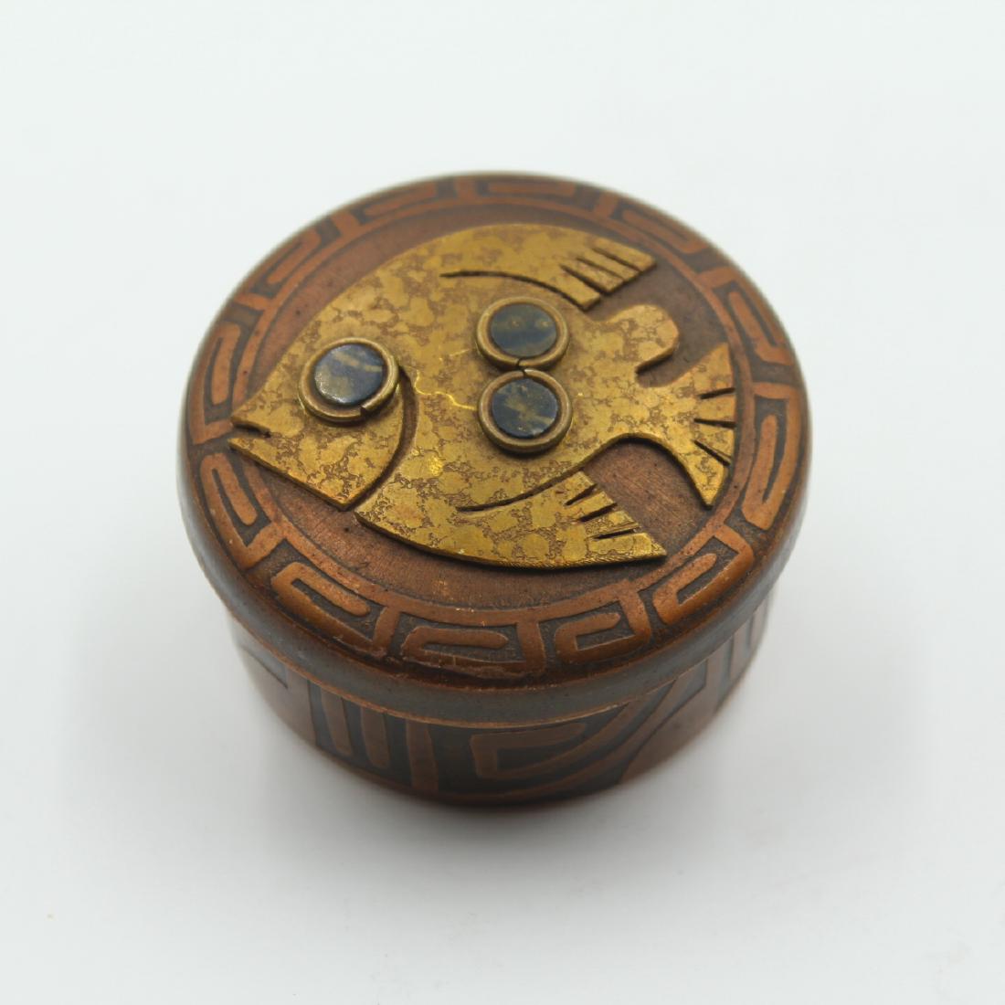 Round Copper and Brass Box: Estimate: $20-$30 Description: Small round copper and brass box with a fish design. Dimensions: 2.5" D x 1.5" H Condition: Very Good.