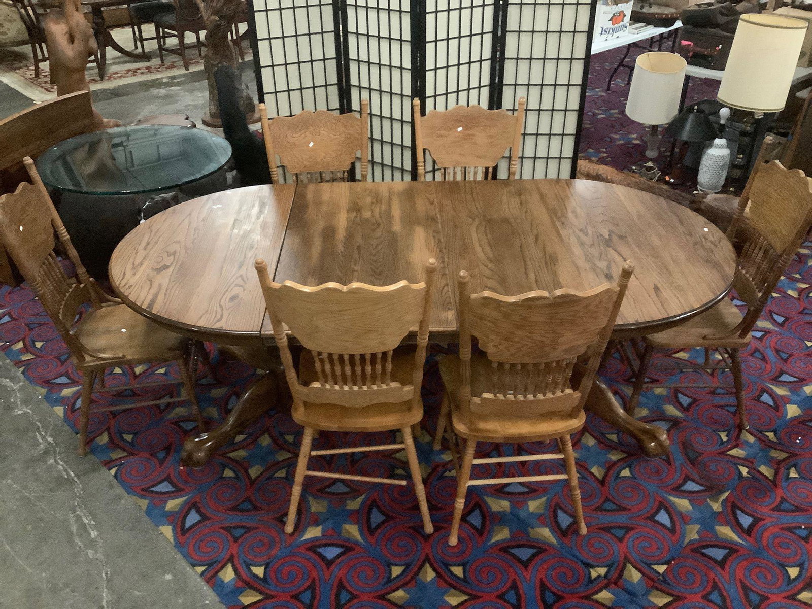 Antique style oak pedestal base claw foot dining table: Round oak claw foot dinning table with 2 leaves and 6 matching wood carved chairs, Measures approx 48x90x30 inches fully extended. BK