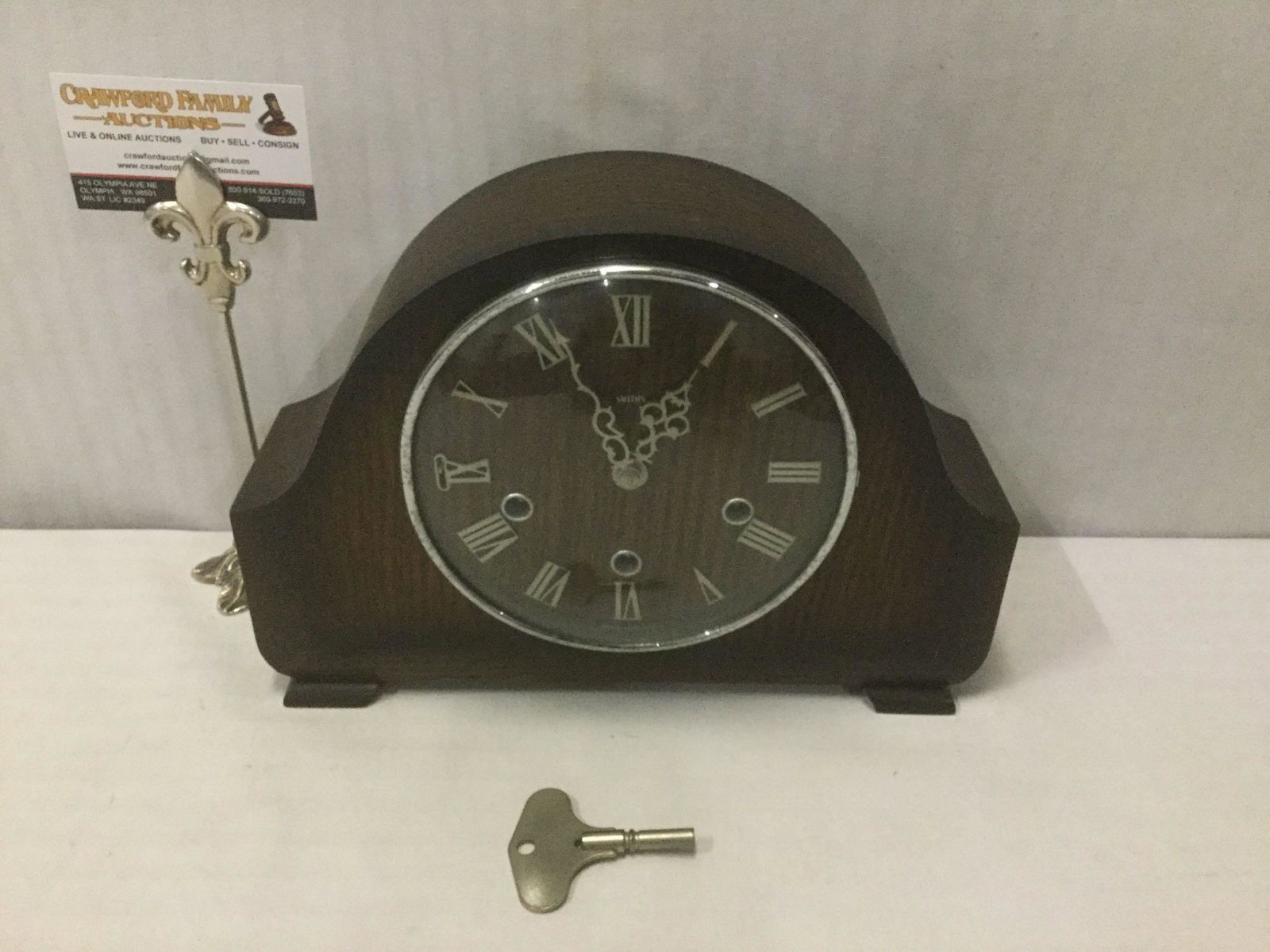 Wooden Smiths 2 jewel unadjusted mantle clock w/ key,: Wooden Smiths 2 jewel unadjusted mantle clock w/ key, untested, approx. 12x4x8 inches.