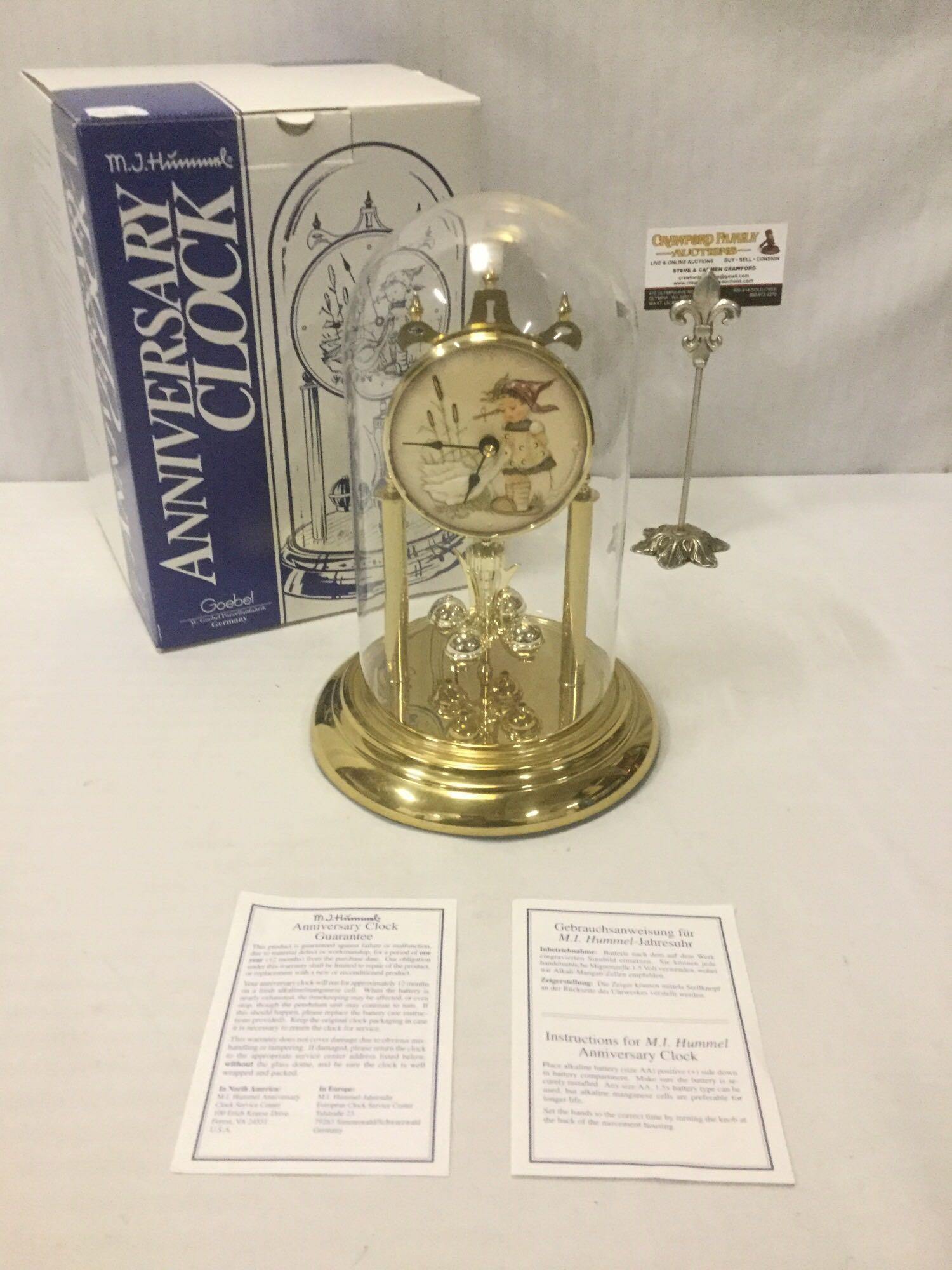 German Goebel M.I. Hummel Jahresuhr Anniversary Clock: German Goebel M.I. Hummel Jahresuhr Anniversary Clock (HUM 750) w/ glass dome, in original box, tested & working, approx. 12x12x9 inches.