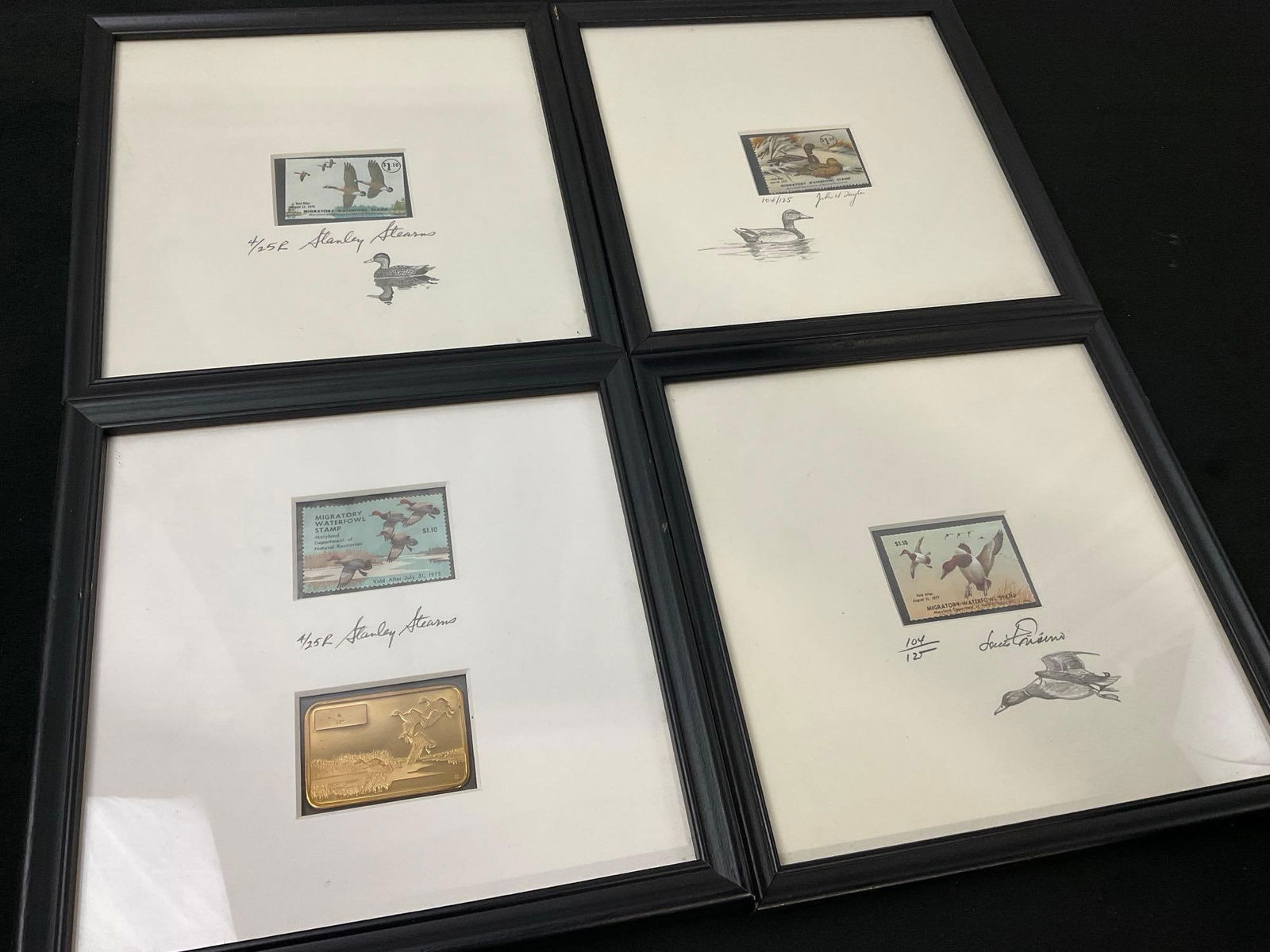 4 Framed Duck Stamps, Signed incl 2 x 4/25 by Stanley Stearns 1 /w matching Sterling Silver Ingot:  Also includes Two Duck stamps signed by 104/125 John Taylor, 104/125 Louis Frisino. What looks like Sterling Silver Ingot, still sealed in the framed piece, unable to weigh