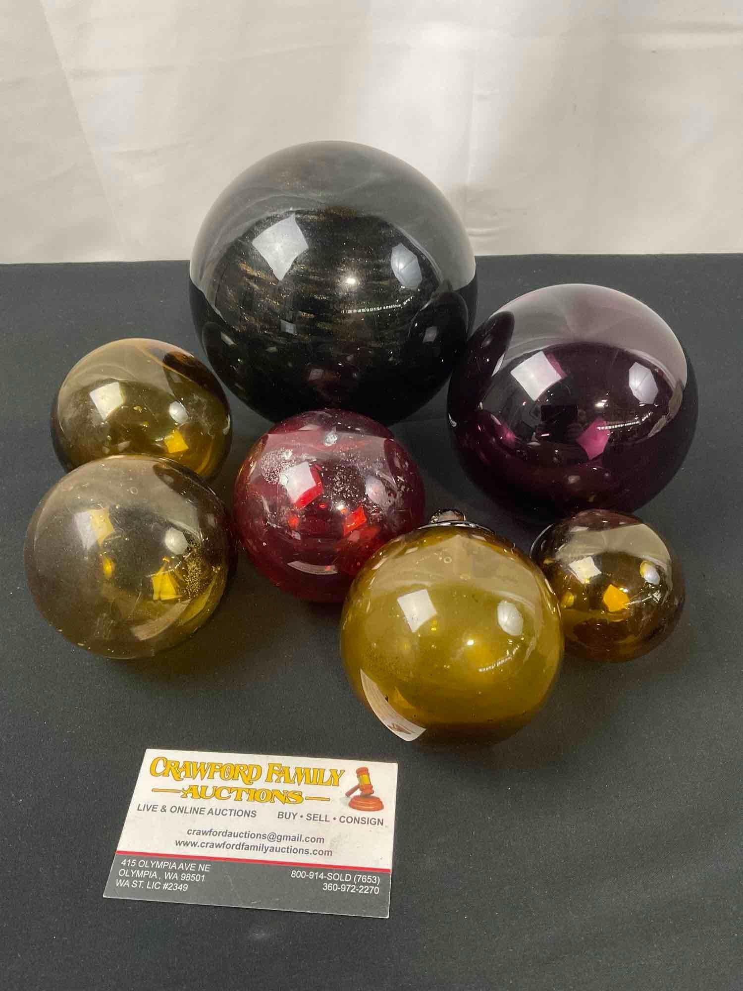 Assortment of Glass Floats, including a few fishnet style yellow floats: Appears to be in good shape. The larger is marked on the clear base what looks like R. Monet 2002, it measures approx 5 inches wide. See pics. E-2659