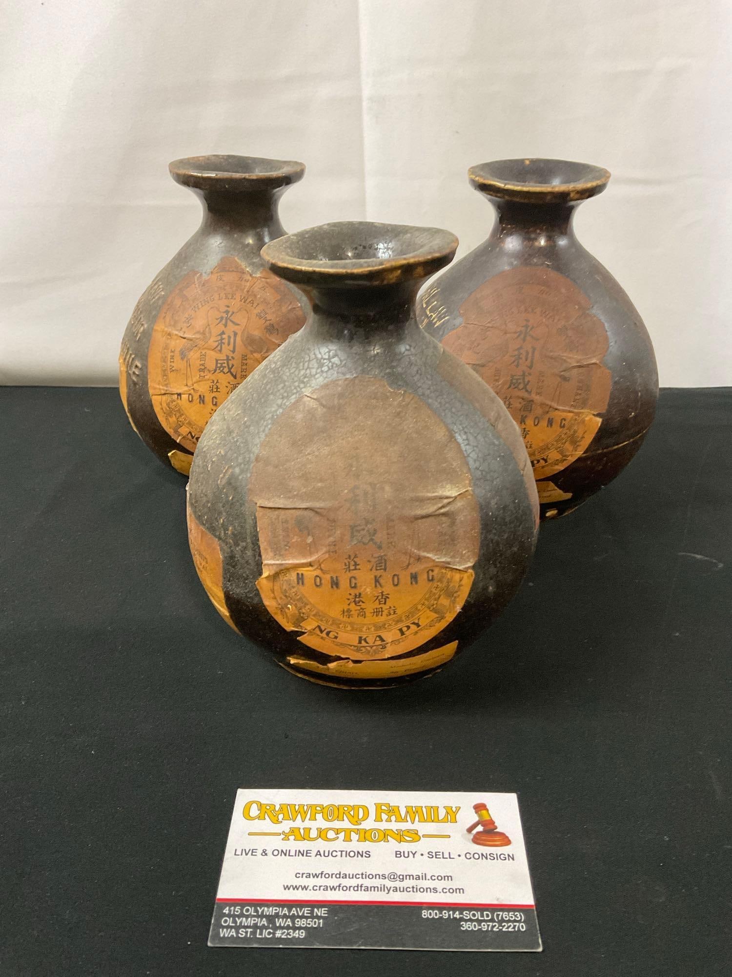 Trio of Prohibition era Wing Lee Wai Hong Kong Ng Ka Py Liquor Bottles, Glazed Brown Porcelain: The rectangular label on the back of all three seems to be partially illegible. The rest of the labels are fragile, take care when cleaning. The bottles measure about 6 inches tall. See pics. E-2687