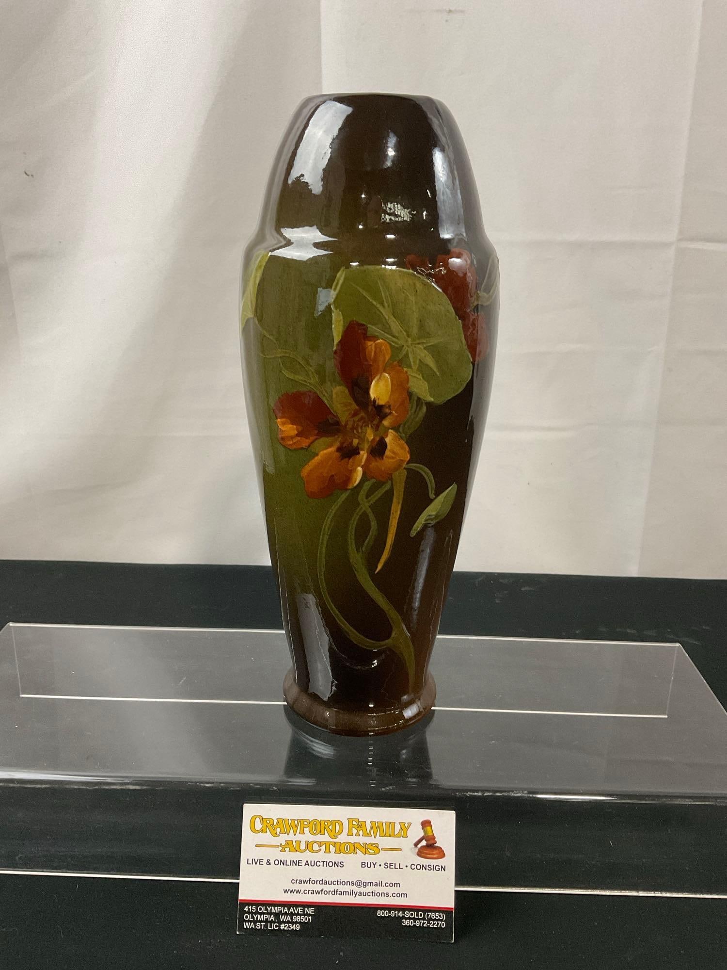 Antique Owens Glazed Pottery Vase, Unique Shape, Floral design on deep brown base: Owens made art pottery between 1896-1907. Marked Owens 05 on the bottom. Appears to be in good shape. The piece measures approx 10.75h x 4.25d inches. See pics. E-2685