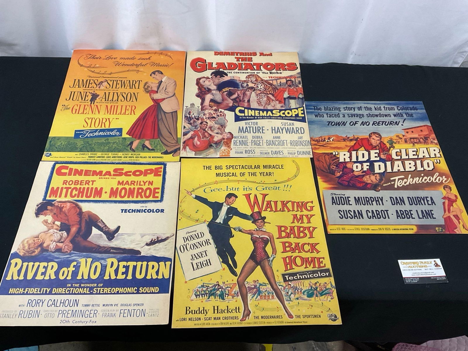 5 Vintage Film Posters, Jimmy Stewart, Marilyn Monroe, Buddy Hackett, Audie Murphy, in movies tit...: The Glenn Miller Story, Demetrius and the Gladiators, River of No Return, Walking My Baby Back Home, Ride Clear of Diablo. Appears to be in fair to good shape. The pieces show a bit of bends and signs