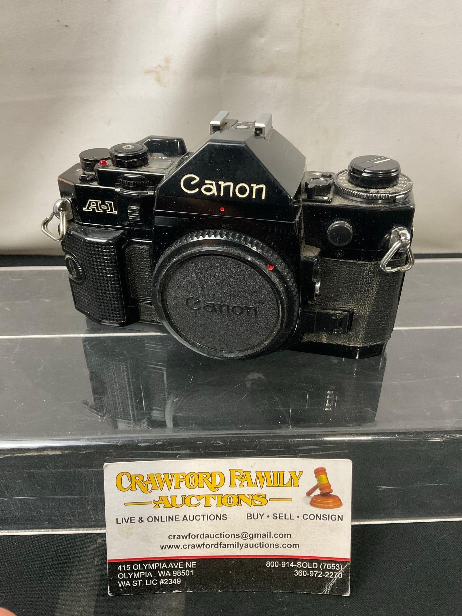 Vintage Canon A-1 SLR 35mm Film Camera, black in color: No. 845437. Appears to be in good shape, seems to operate smoothly. See pics. E-414