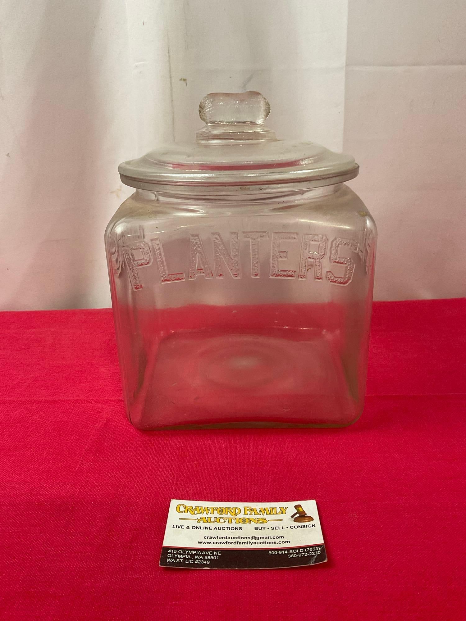Planters Peanut Glass Jar w/ Lid, Peanut Finial, 9.5 inches tall: Appears to be in good shape. The piece including the lid measures approx 9.5h x 7w x 7d inches. See pics. E-3190