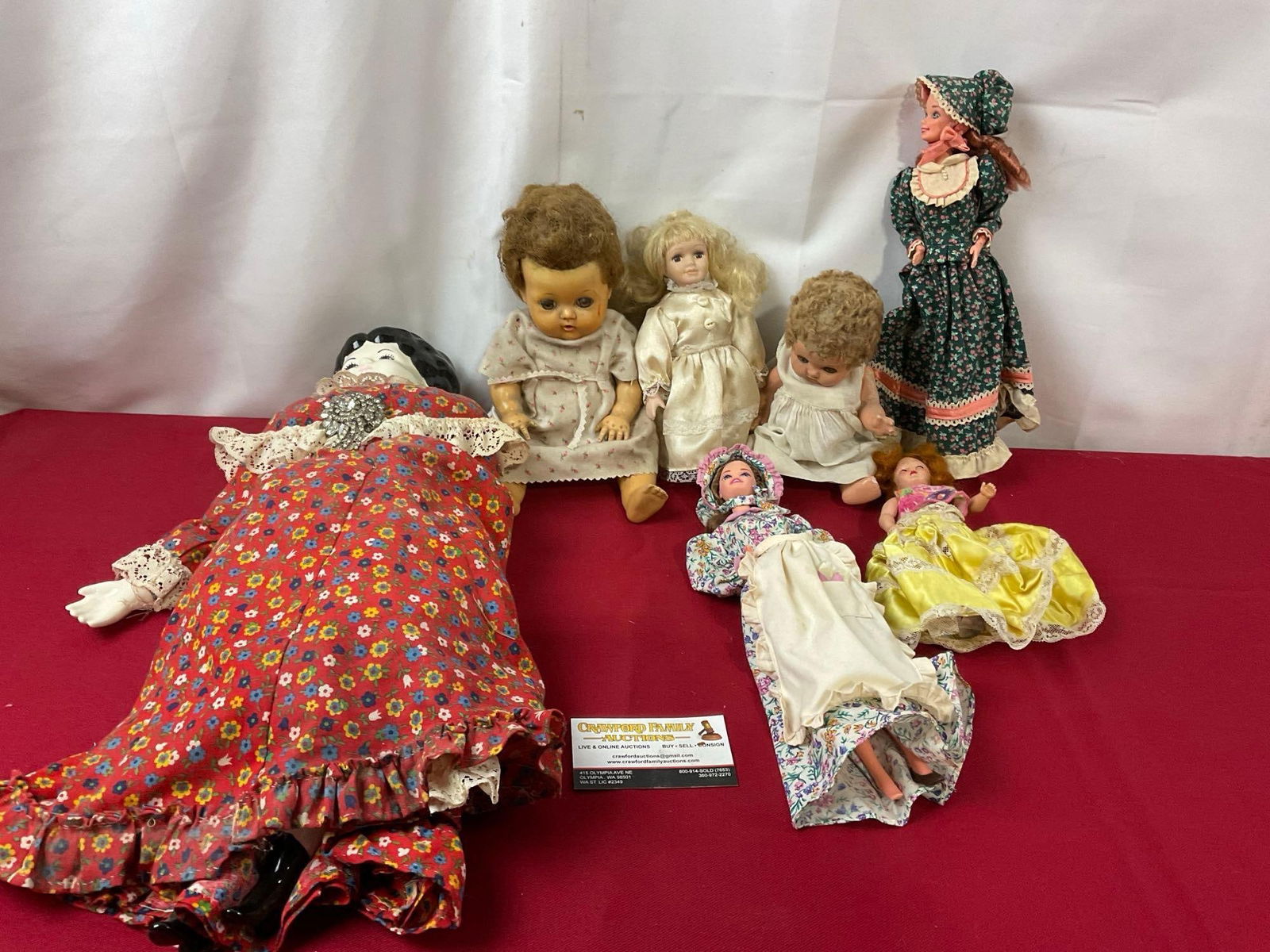 Group of Vintage Dolls, Pair of Barbies, Effanbee Doll, Porcelain Unmarked, and more: The pair of barbies seem pieced together, the torso pieces are marked 1966 Indonesia, but the other parts do not match. Appears to be in fair to good shape. The largest doll measures approx 16 inches