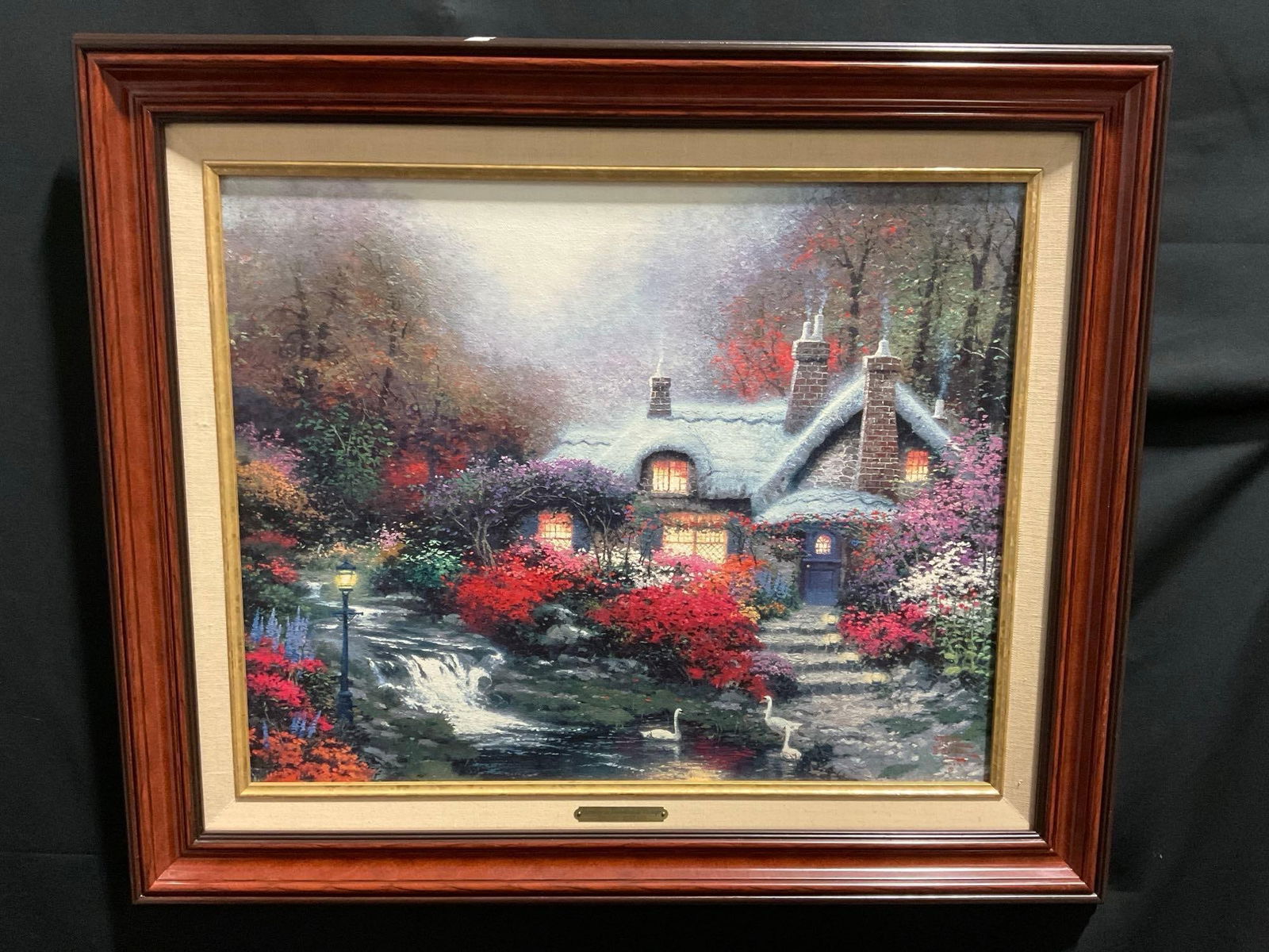 Framed Repro of Evening at Swanbrooke Cottage, Thomashire by Thomas Kinkade, 21.5h x 26.5w in w/ ...: Appears to be in good shape. The piece measures approx 21.5h x 26.5w inches. See pics. E-3890