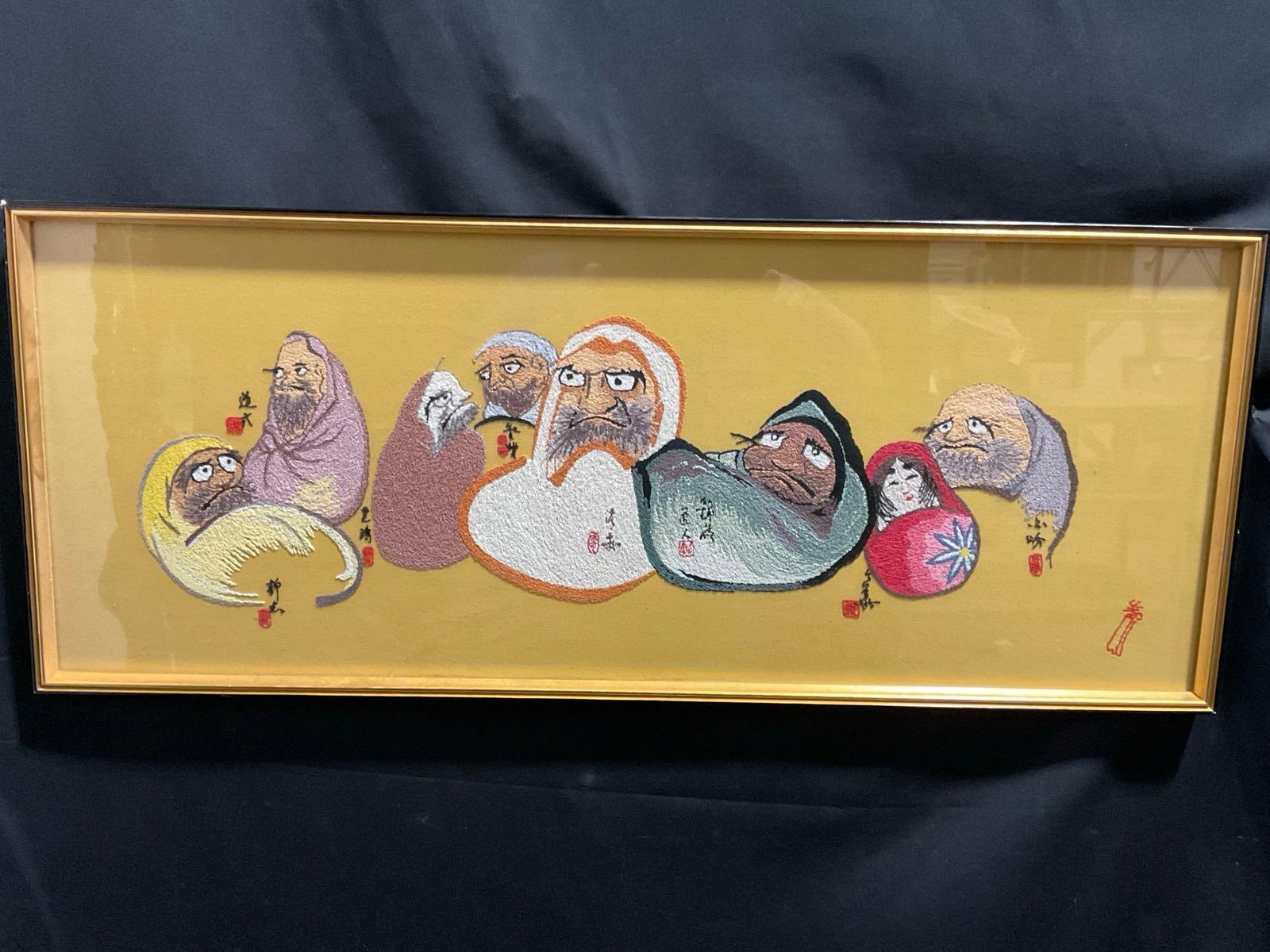 Framed Japanese Daruma Nishijin Embroidery, 15.5h x 38w inches: Appears to be in good shape. The piece measures approx 15.5h x 38w inches. See pics. E-3980
