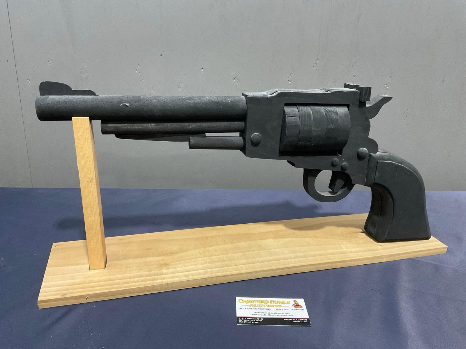 Large Wooden Revolver Figure painted black w/ Stand, the gun is 10h x 24L inches: Appears to be in fair to good shape. The piece measures approx 10h x 24L inches. See pics. E-4140