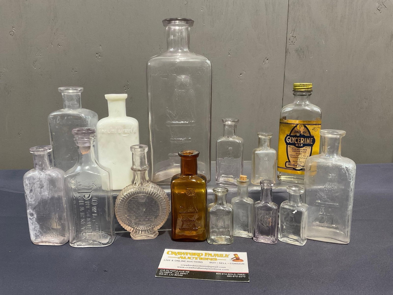 Variety of The Owl Drug Bottles, approx 15 pieces, varied sizes, largest is about 8 x 3 x 2.5 inc...: Appears to be in good shape. The largest bottle measures 8.5h x 3.5w x 3d inches. See pics. E-4030