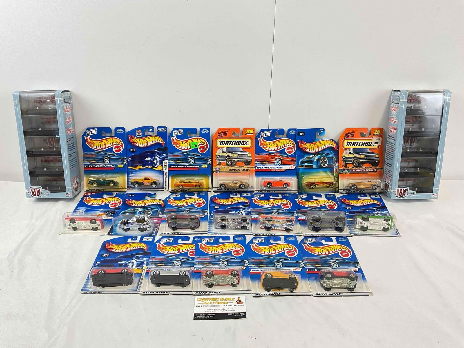 19 NIP 1:64 Scale Die Cast Model Cars from Hot Wheels/Matchbox & 2x M2 Machines Cases.: 19 NIP 1:64 Scale Die Cast Model Cars from Hot Wheels/Matchbox & 2x M2 Machines Cases. Minor shelf wear, condition is otherwise very good. Fits in a box measuring 12" x 18" x 5" DM-4050