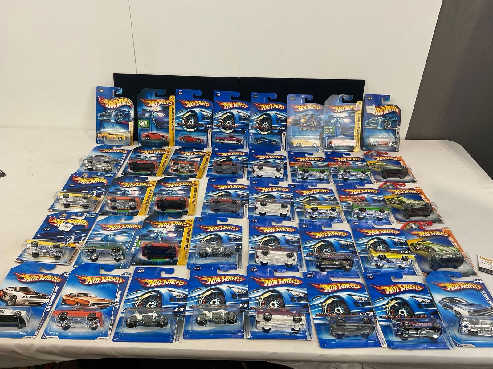40 Hot Wheels Diecast Cars, NIP 1:64 Scale, Mopar Dodge, Plymouth & Chrysler & more: Includes 2004-2008 New Models. Appears to be in good shape. The pieces fit in a box that measures approx 8h x 19w x 13d inches. See pics. E-4050