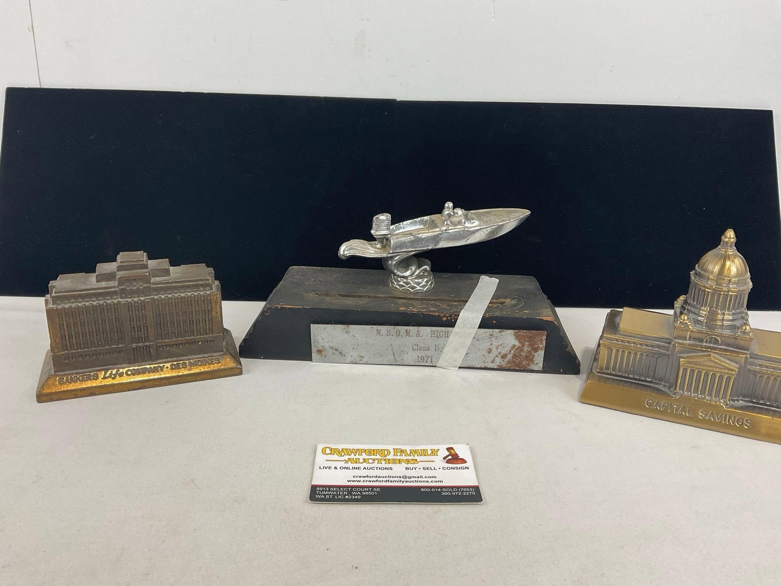 Pair of Cast Brass Coin Banks, Capital Savings & Bankers Life Company Des Moines & Boat Racing Aw...: Appears to be in good shape, some missing finish. The piece measures approx 8h x 11w x 9d inches. See pics. E-4400