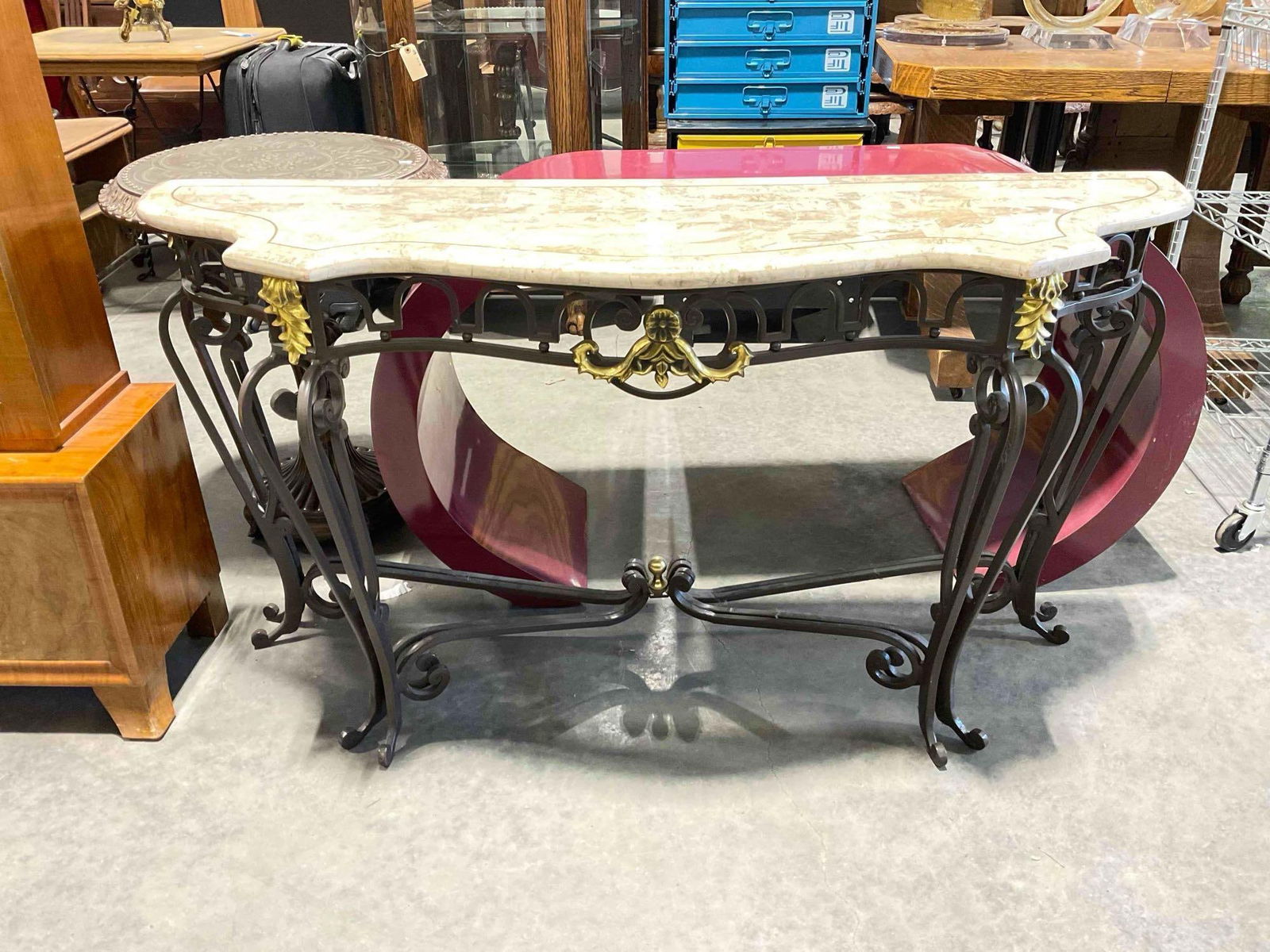 Modern Serpentine Marble Composite Console Table w/ Wrought Metal Base. Excellent Cond.: Modern Serpentine Marble Composite Console Table w/ Wrought Metal Base. Excellent Cond. Ornate shape and detailed legs with brass decor. Measures 54" x 17" x 29" DM-4720 *Freight Required if ship