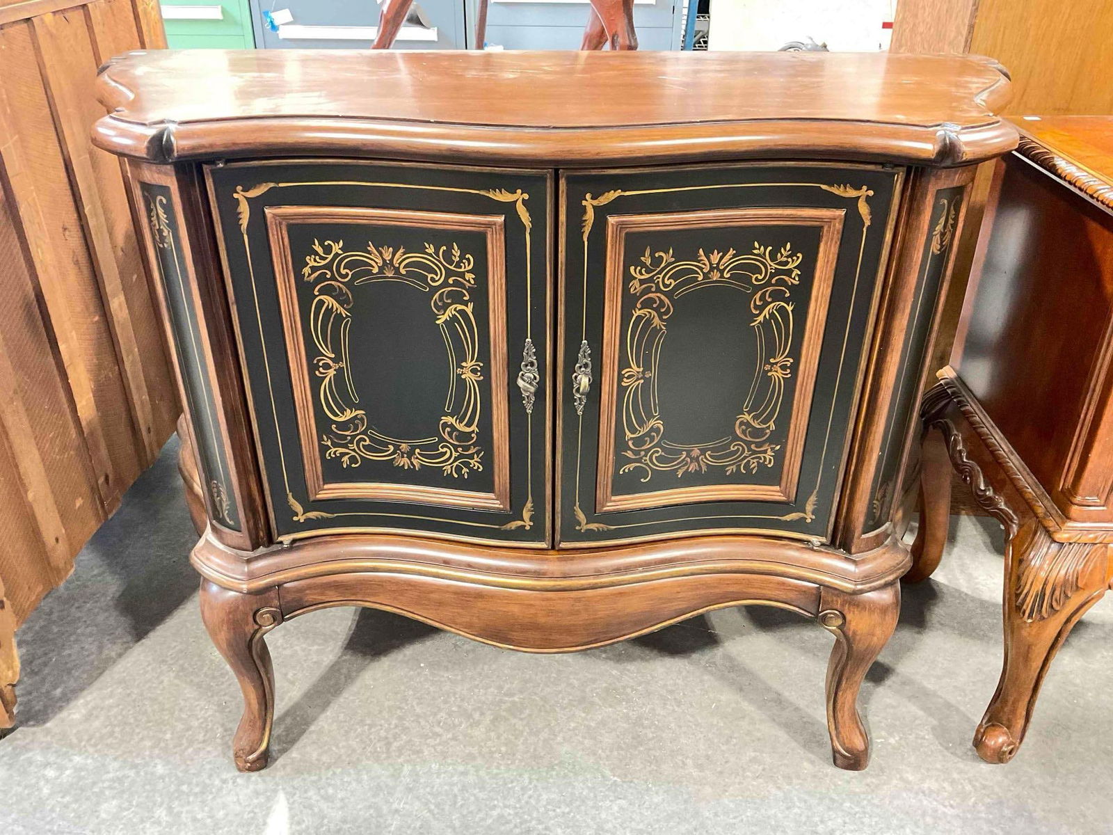 Modern Wood Finish Serpentine Console Table w/ Cabinet & Painted Details. Very Good Cond.: Modern Wood Finish Serpentine Console Table w/ Cabinet & Painted Details. Minor wear indicative of use, otherwise in Very Good Condition. Measures 48" x 19" x 36" DM-4720 *Freight Required if