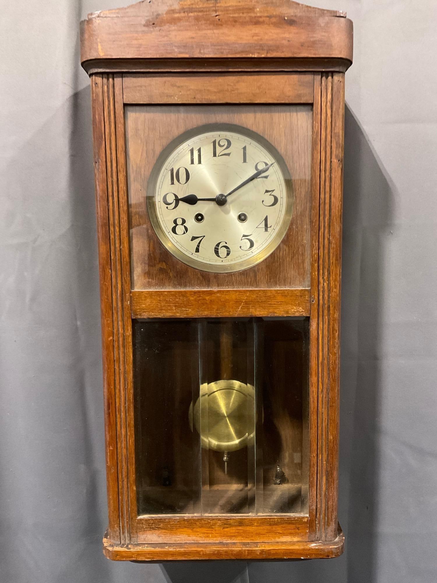 Vintage Hamburg American Corporation, German Time Strike Wall Clock, 30h x 13w x 8d inches: Includes Pendulum & Key. Appears to be in good shape. The piece measures approx 30h x 13w x 8d inches. See pics. E-5130 *Oversized shipping may apply*