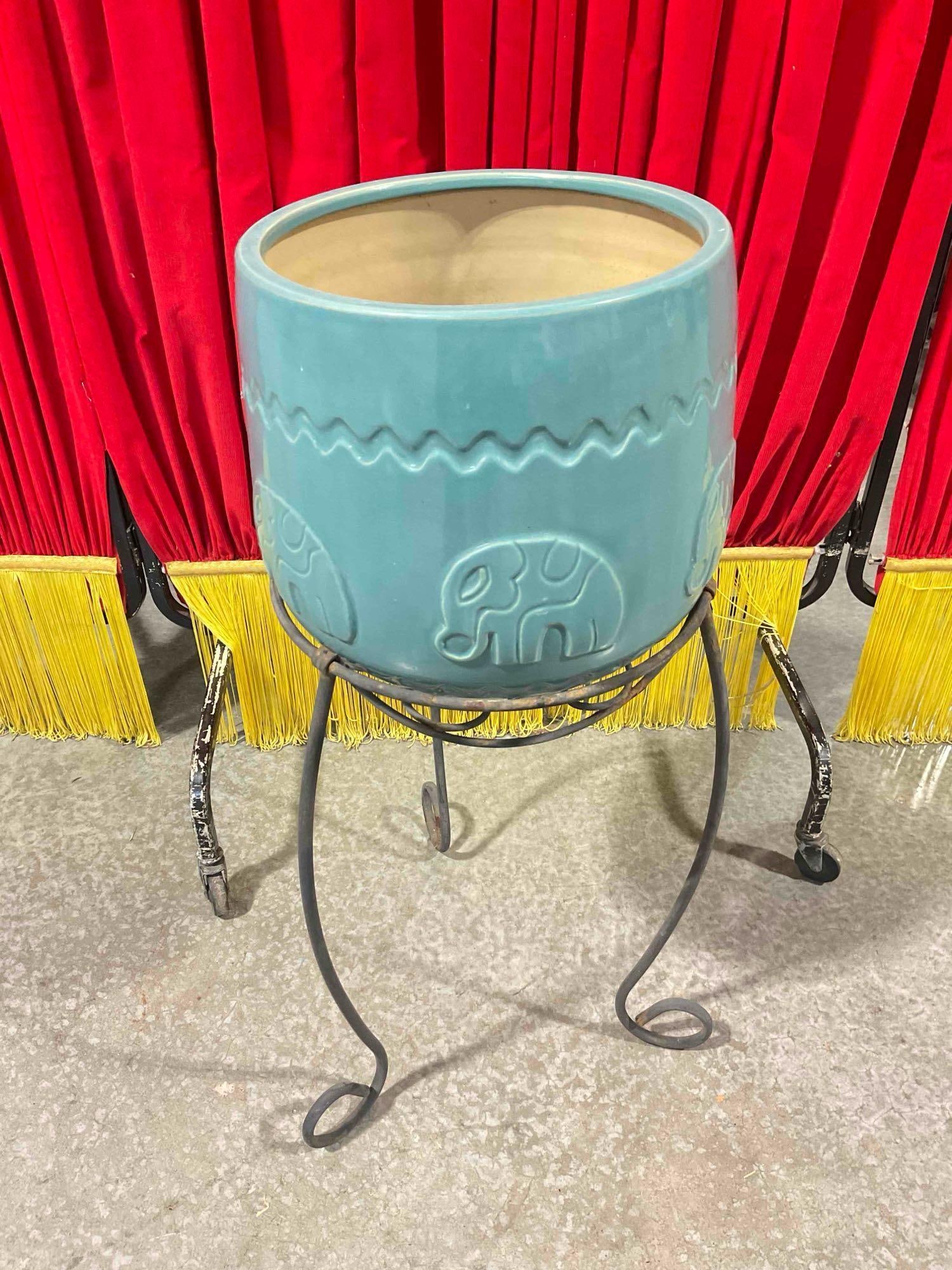 Charming Turquoise Ceramic Planter Pot w/ Elephants on Metal Stand. Good Condition. See pics.: Charming Turquoise Ceramic Planter Pot w/ Elephants on Metal Stand. Good Condition. Metal stand itself is tired, pot itself is in good condition with a few dings and dirt stains. Measures 12" x 12" x