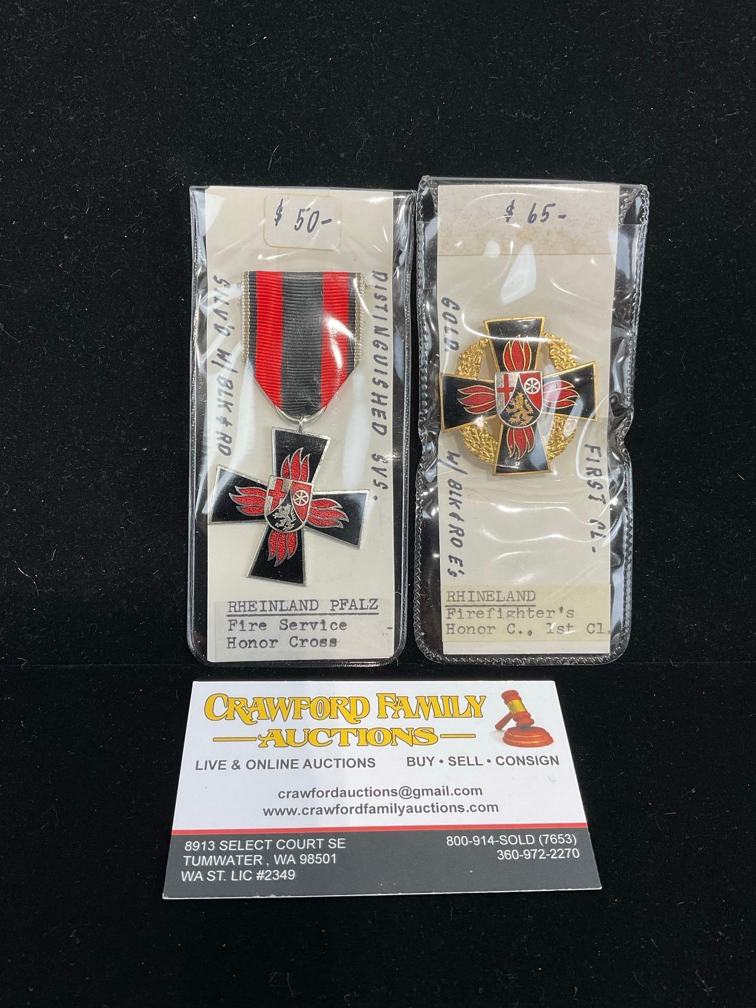 Pair of German Medals, Rheinland Pfalz Fire Service & Firefighters Honor Cross 1st Class: All from a single collection, these are briefly described on the tag and were kept in a display. They measure approx 6h x 3w x 2d inches. See pics. E-5300