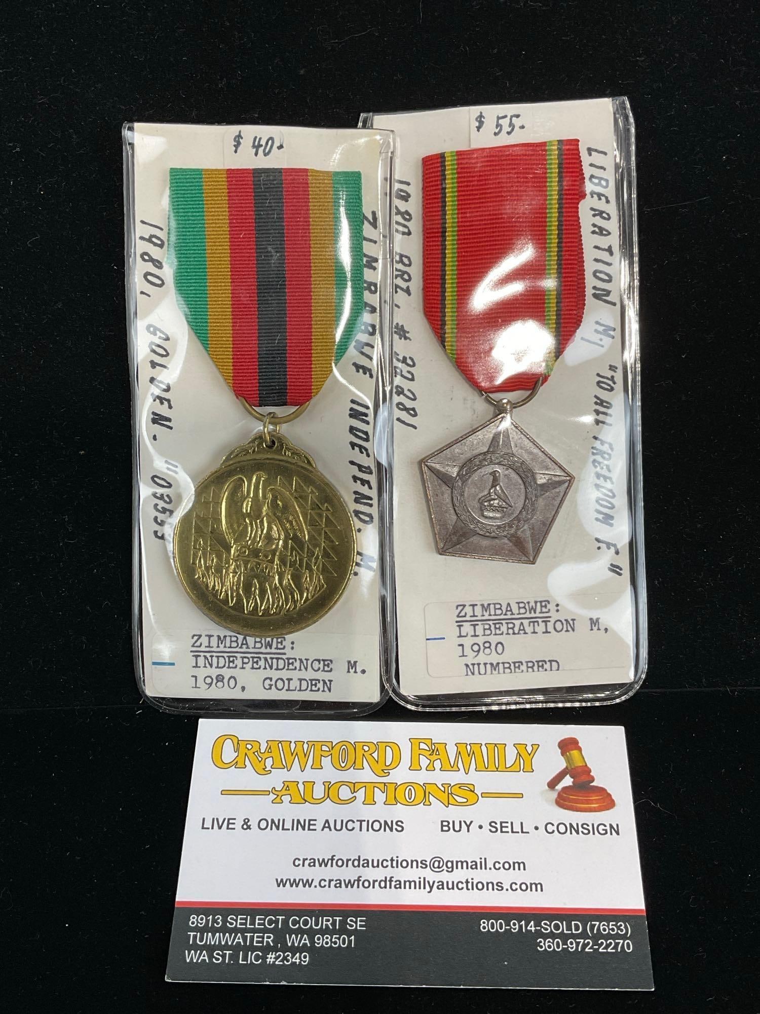 2 Zimbabwean Medals, Independence 1980 Golden & 1980 Pentagon, Liberation: All from a single collection, these are briefly described on the tag and were kept in a display. They measure approx 6h x 3w x 2d inches. See pics. E-5300