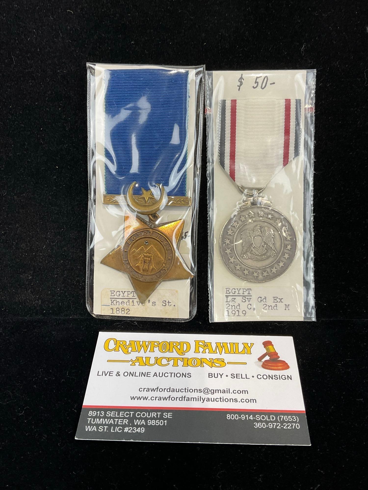 Pair of Egyptian Medals, Khedives St. 1882 & Long Service GD. EX. 2nd Class, 2nd M 1919: All from a single collection, these are briefly described on the tag and were kept in a display. They measure approx 6h x 3w x 2d inches. See pics. E-5300