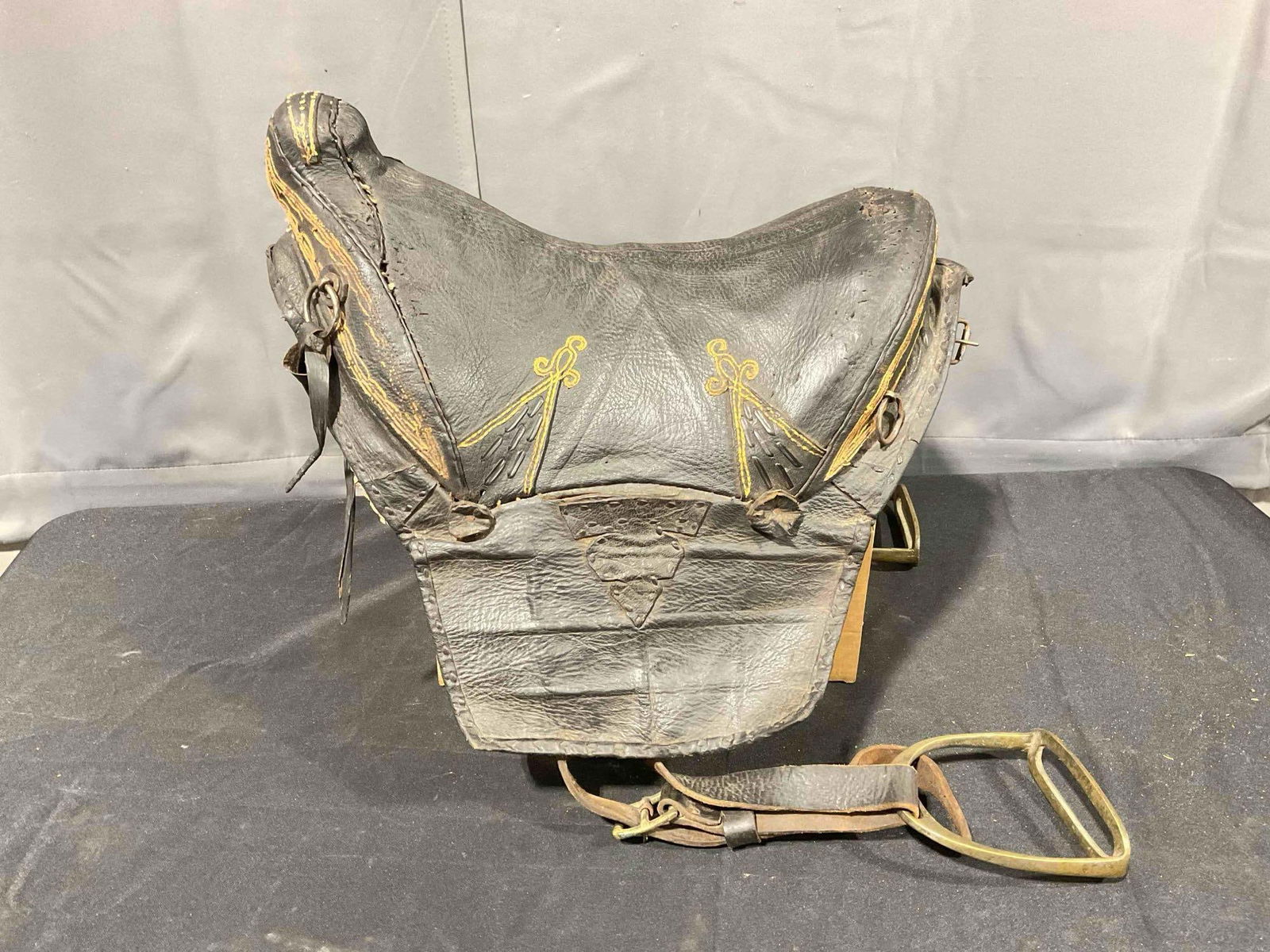 Antique Primitive Black German Leather Saddle w/ Wooden Tree & Brass Stirrups. Good Condition. See: Antique Primitive Greman Black Leather Saddle w/ Wooden Tree & Brass Stirrups. Good Condition. Wear indicative of age, underside is stained and tired, condition is otherwise good. Consignor lived