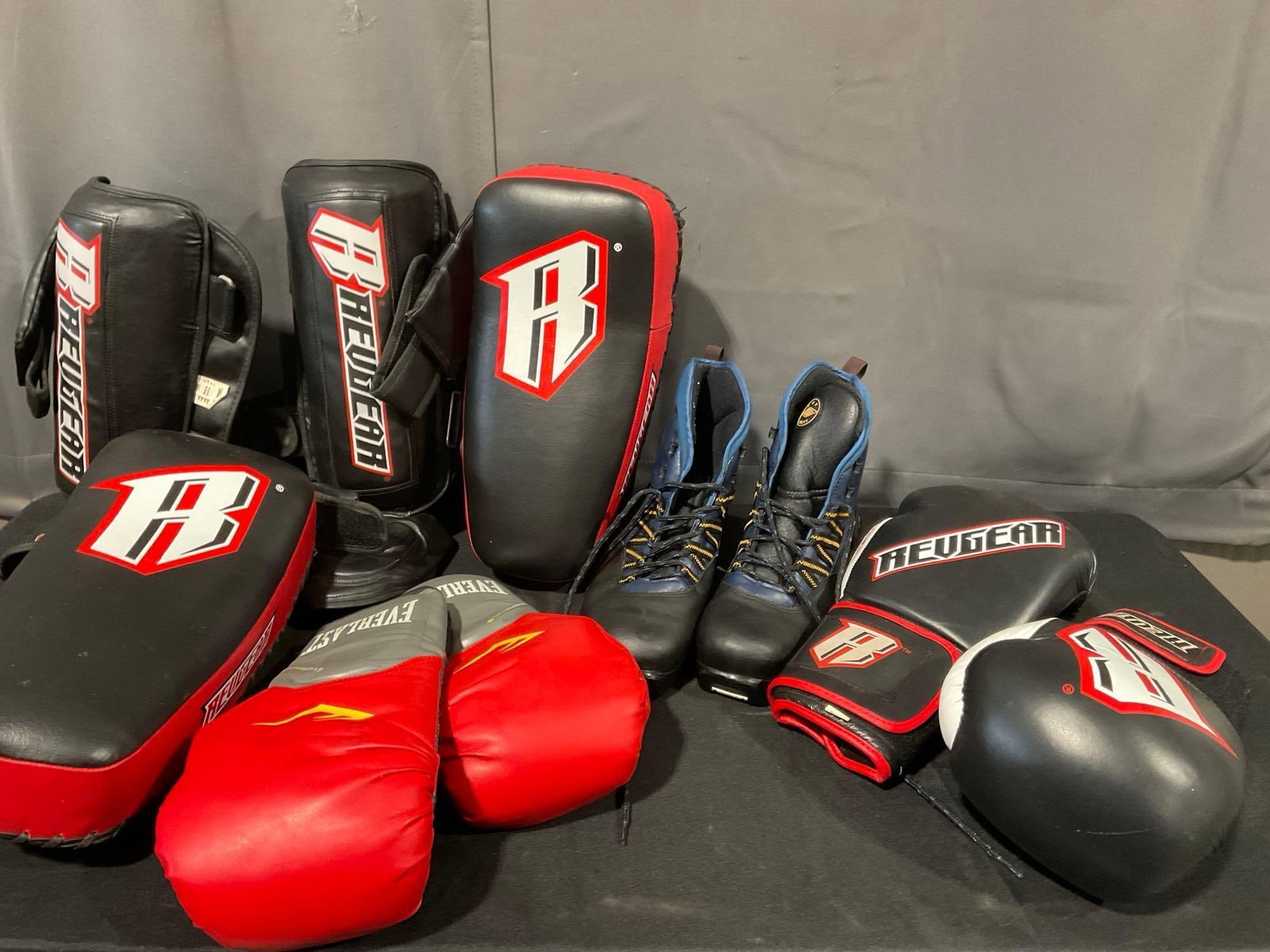 Revgear Gloves, Shin Guards, & Assassin Muay Thai Pads, Everlast Gloves, & Merrill Mens 11.5 size: Appears to be in good shape. The piece measures approx 19h x 24w x 19d inches. See pics. E-5180