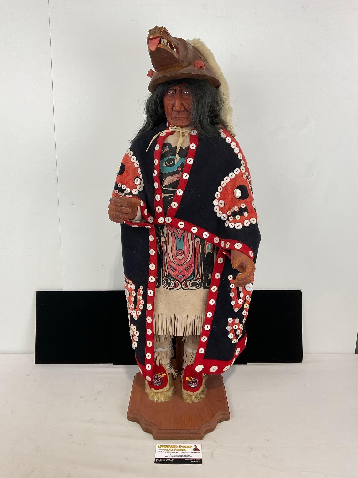 Hand carved wooden Most Most Likely Pacific NW 1st Nations Native American Doll W/ Wolf Mask: Doll Is not Singed But is attributed to Erla Graham . The detail is amazing with a cape that is adorned with Mother of Pearl Buttons, the Head dress is hand carved wooden Wolf Mask W/ mother