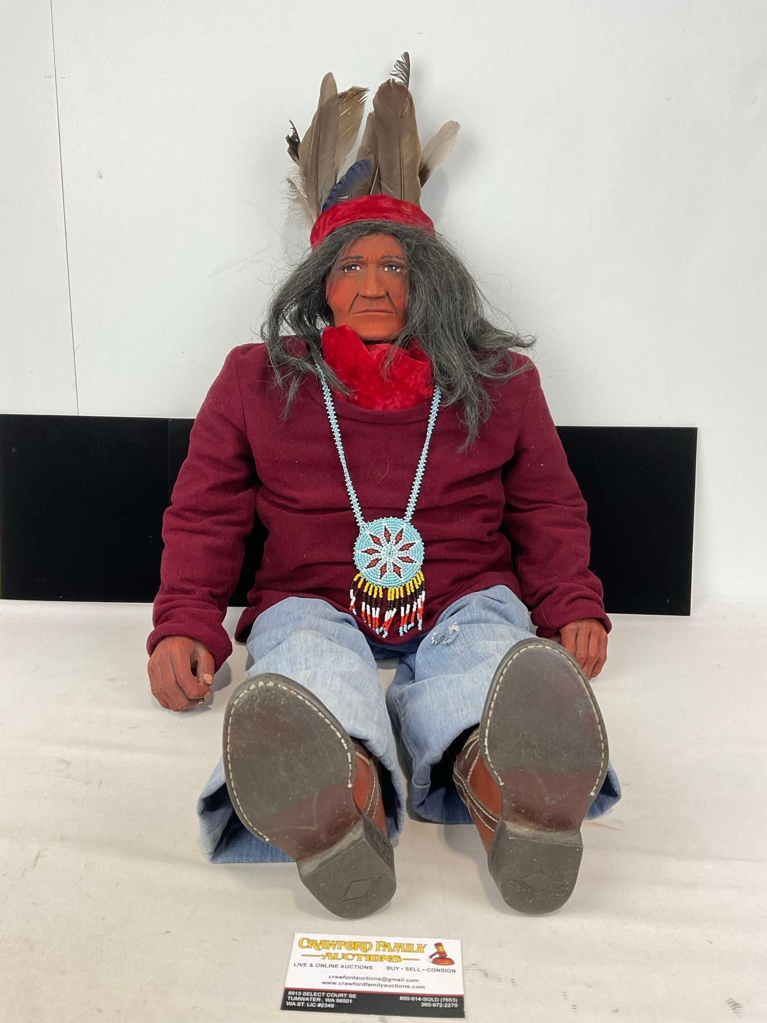 Large Seated Native American Doll, 33h x 16w x 7d in, handbeaded necklace, Feather Headdress: Has a sweater, jeans, and boots on, which has some wear. Appears to be in good shape. The piece measures approx 33h x 16w x 7d inches. See pics. E-5320 *Oversized shipping may apply* 